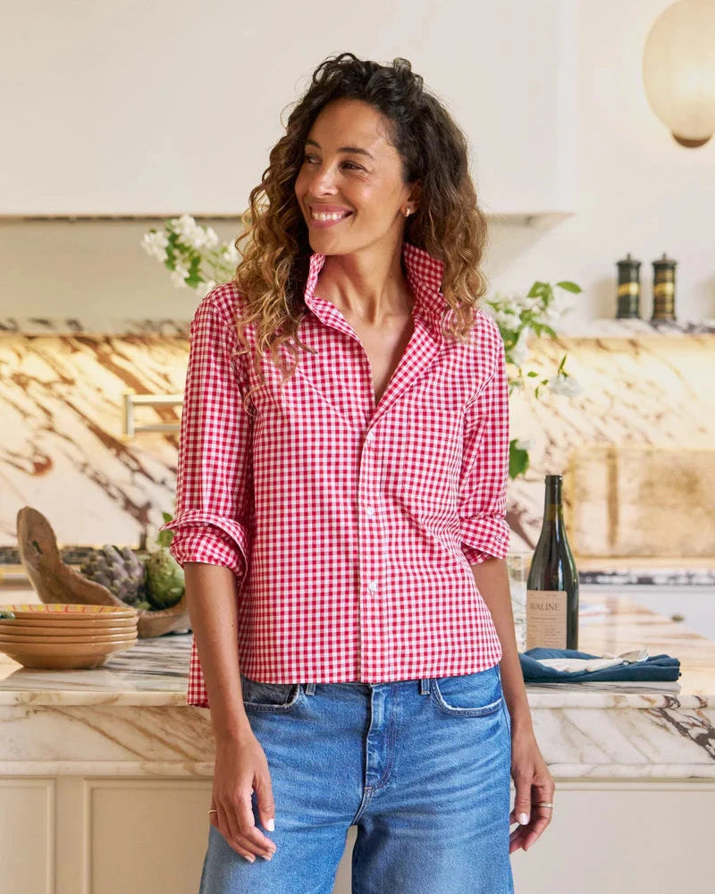 Woman wearing a red and white checkered shirt in a kitchen