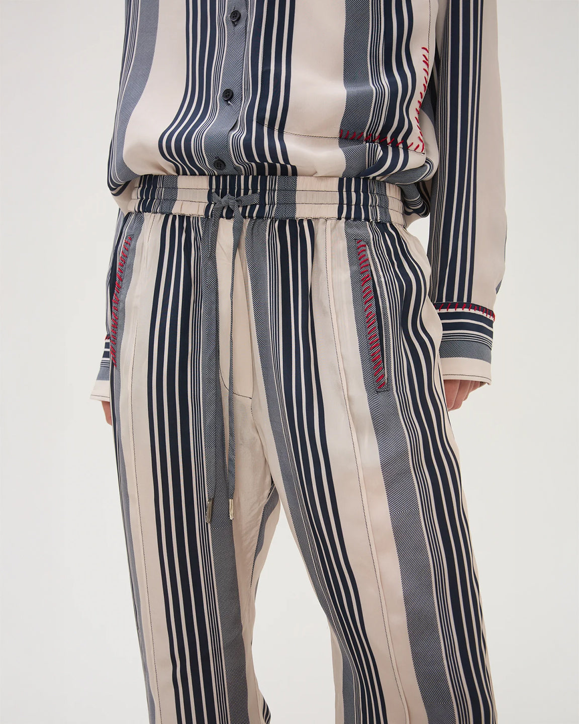 Striped shirt and pants with a belt on a white background