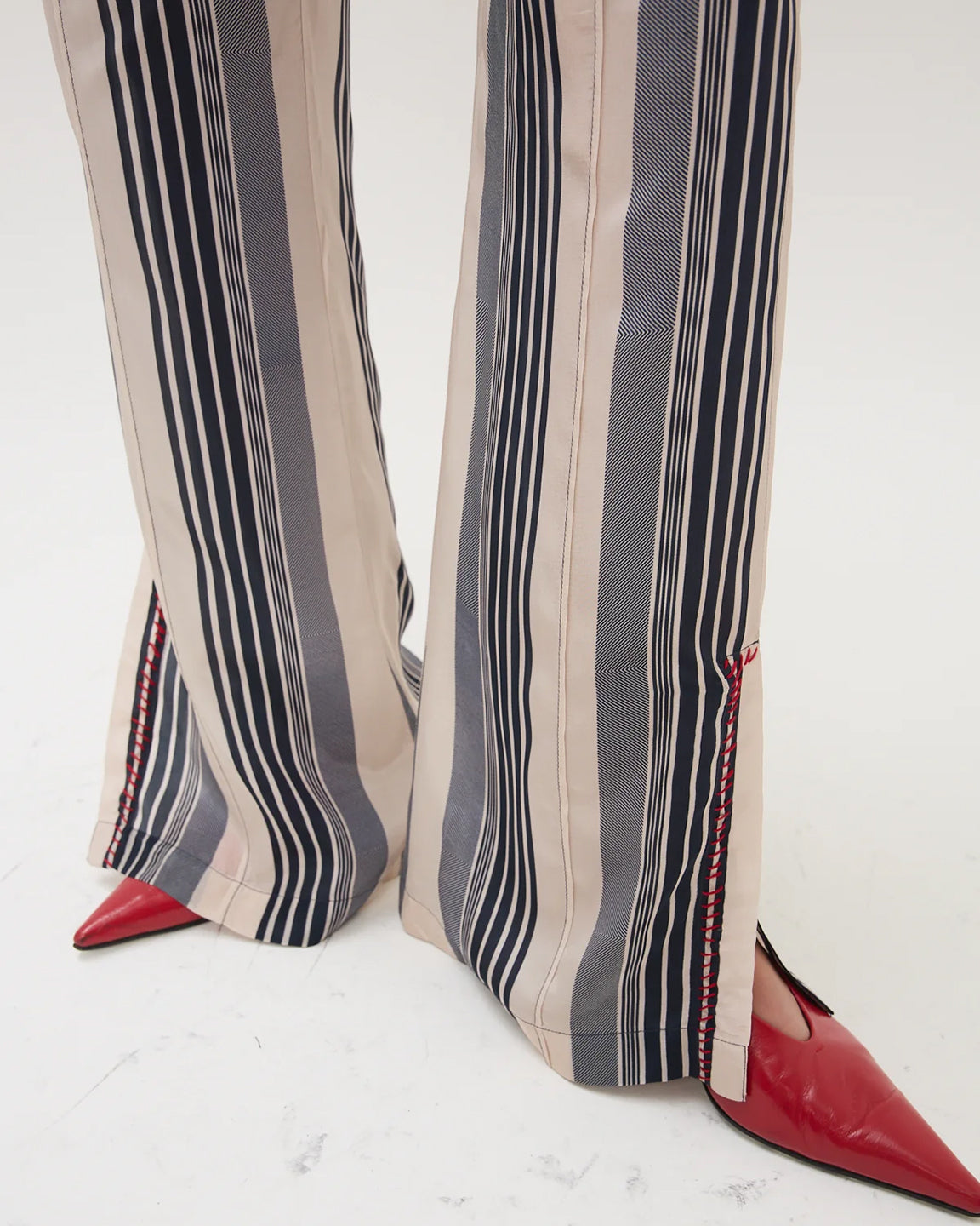 Striped pants with red shoes on a white background