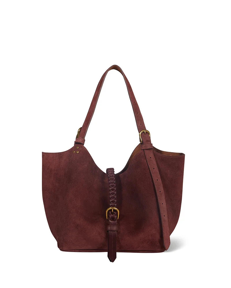 Brown leather handbag with a strap on a white background
