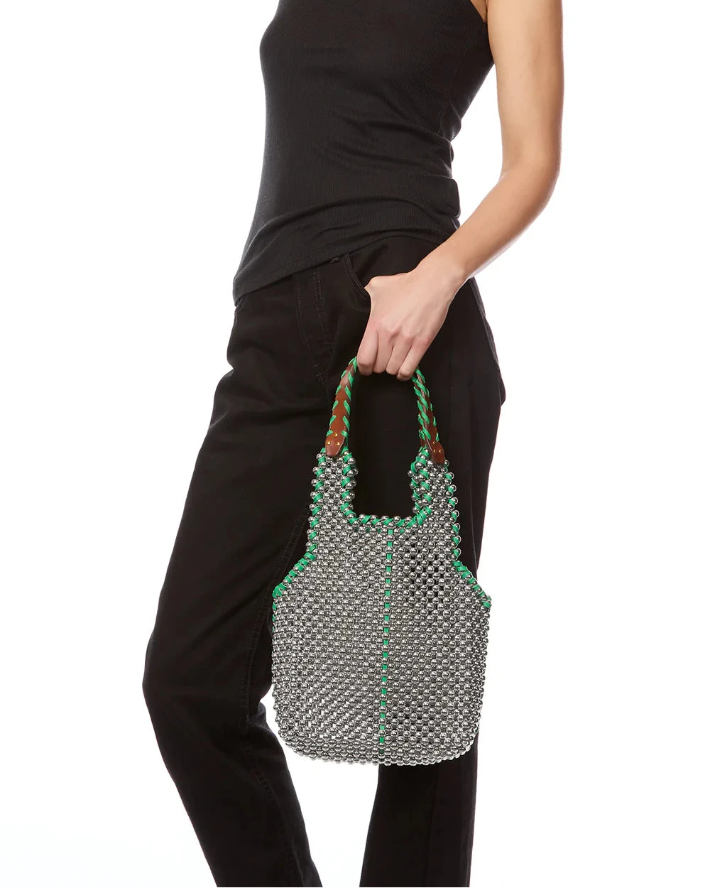 silver beaded bag with green leather trim - and leather handles carried by a girl in a black tank and pants.