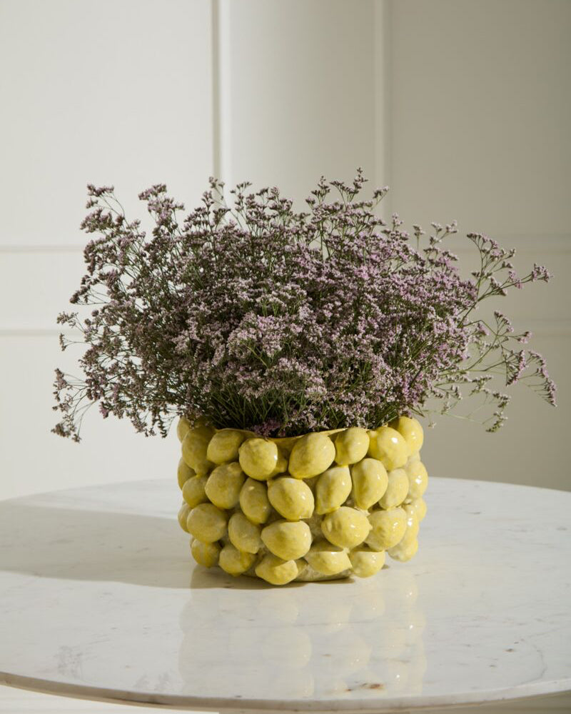 Decorative vase with flowers on a marble surface