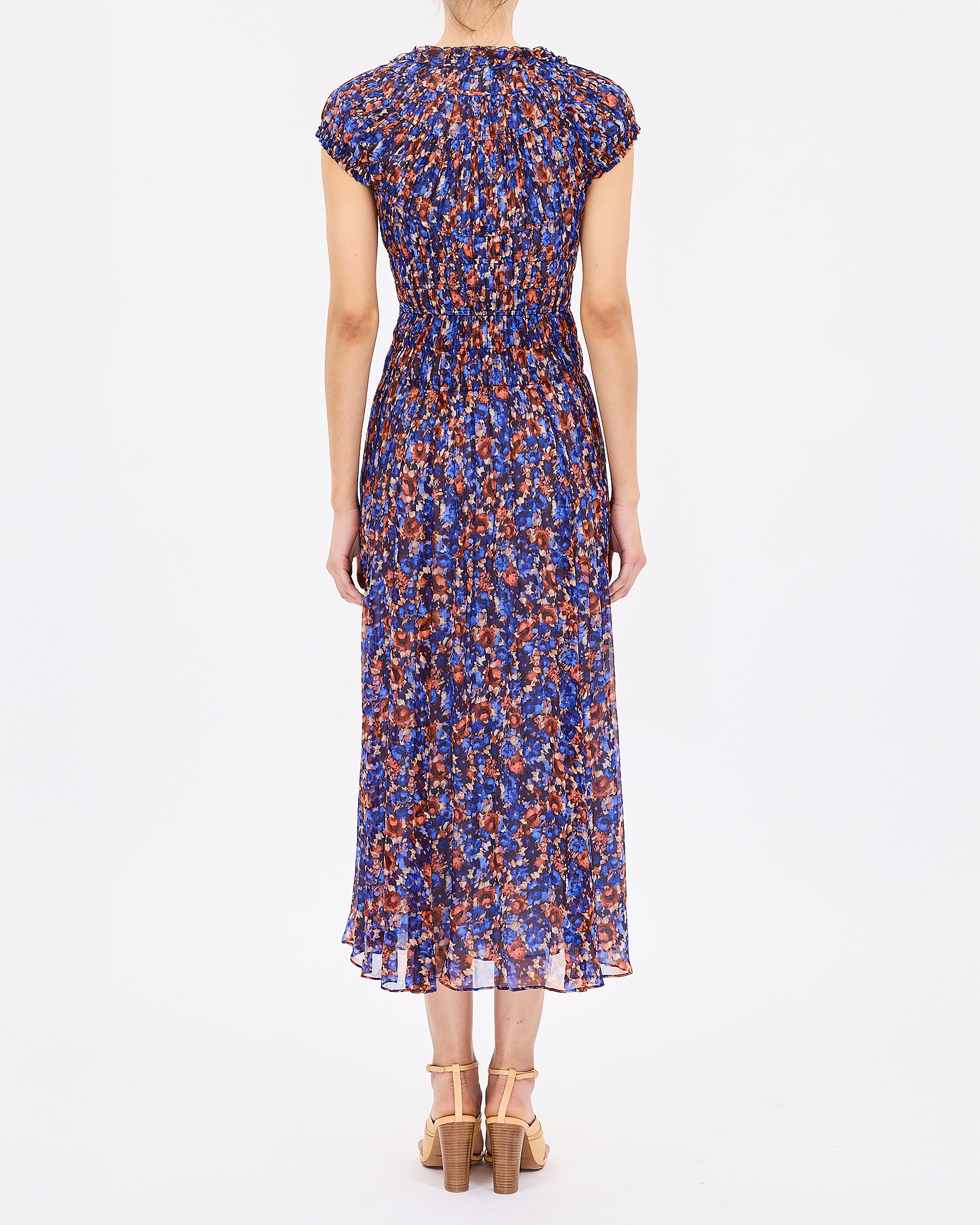 Woman wearing a blue floral dress on a white background