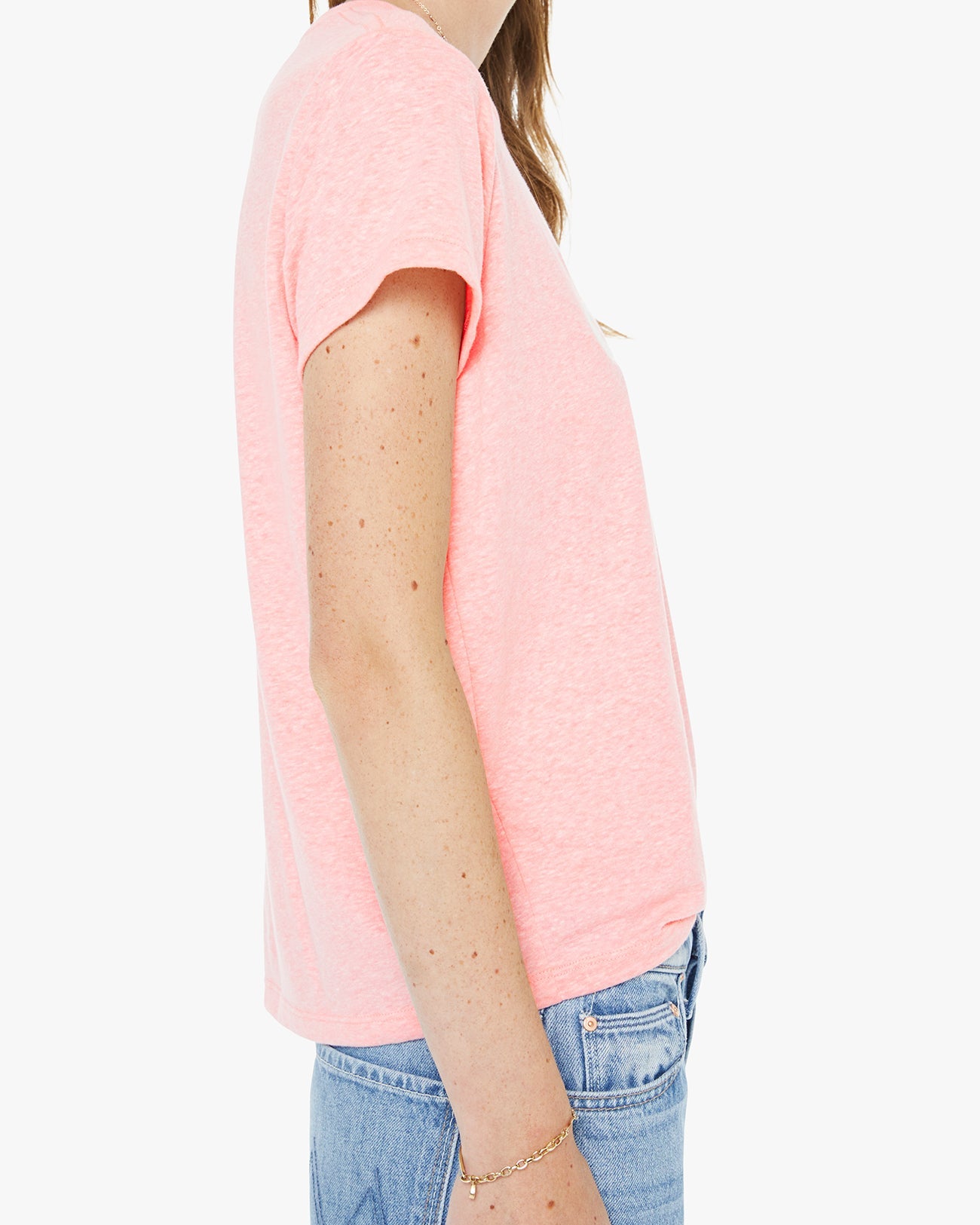 Person wearing a pink t-shirt and blue jeans on a white background
