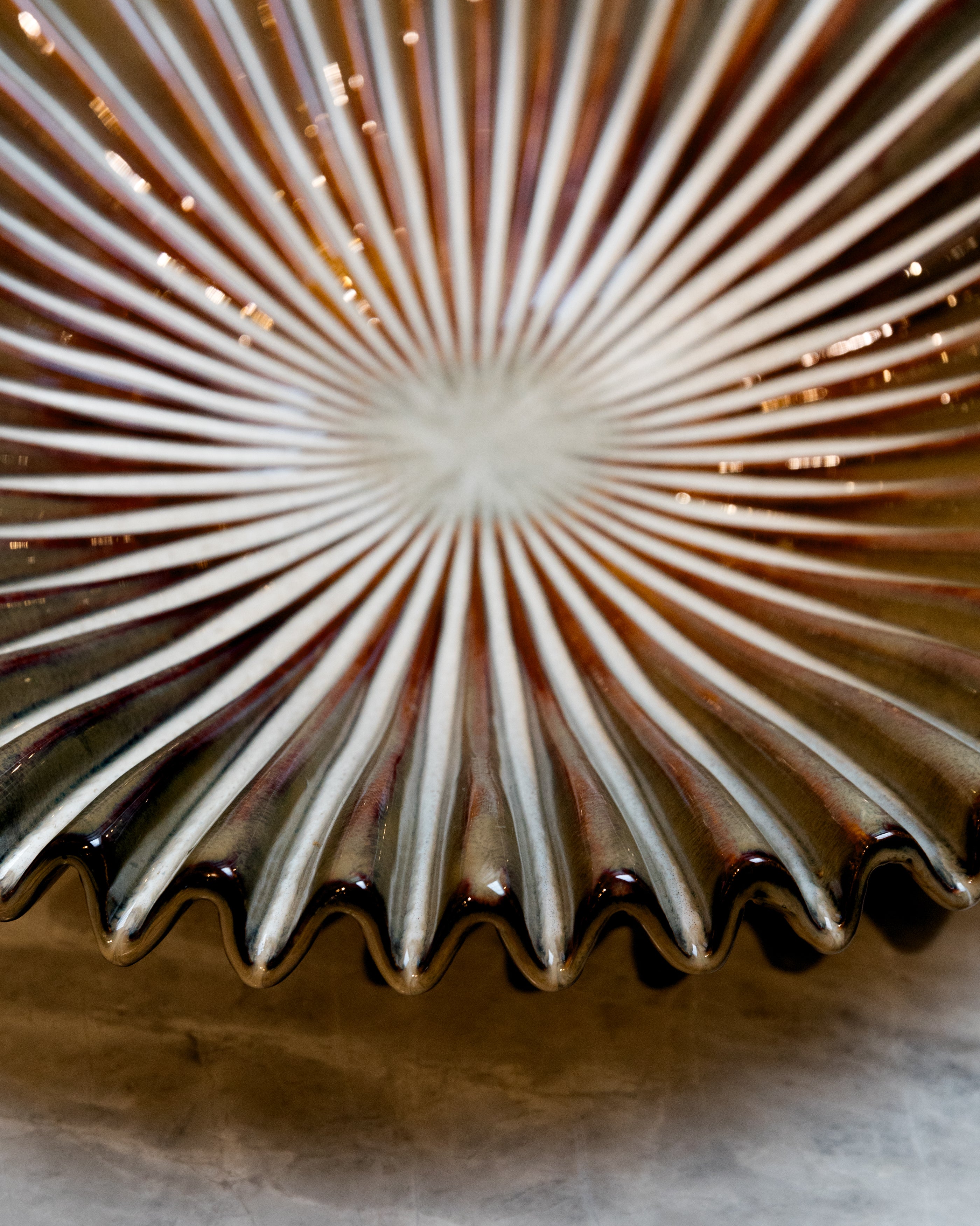 Close-up of a textured ceramic plate with concentric circular patterns.