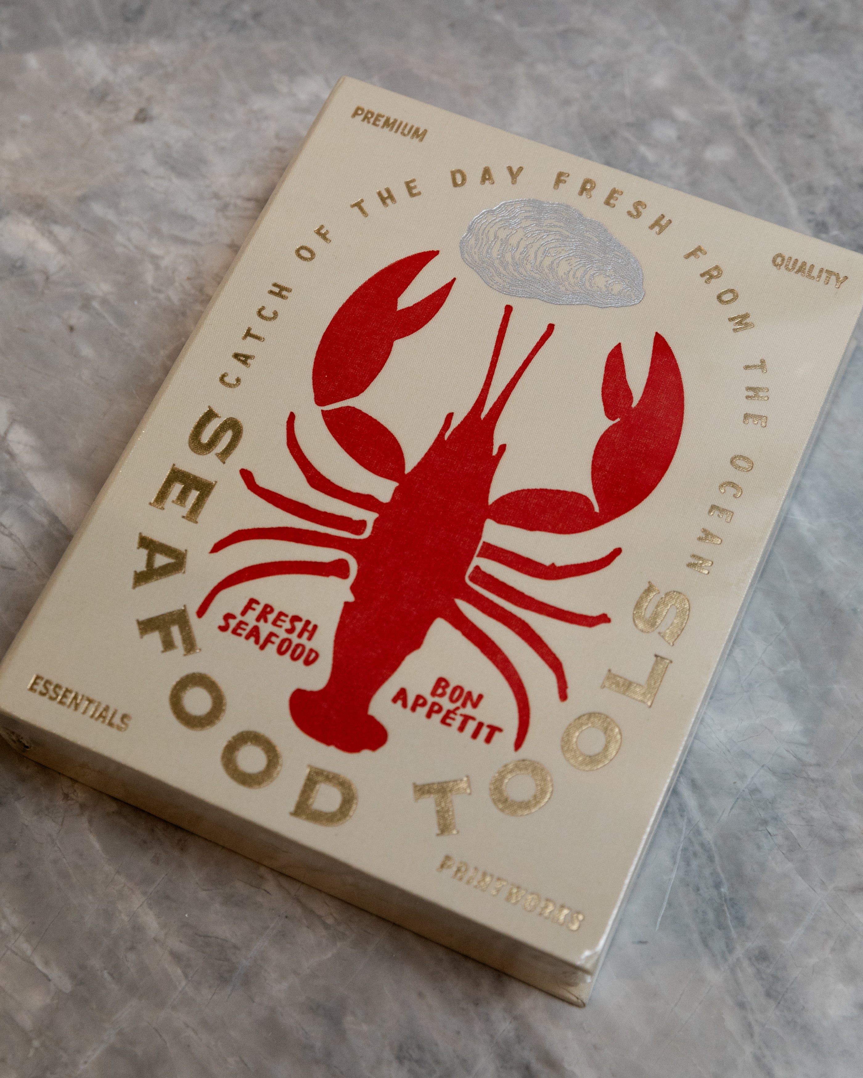 seafood tools kit in what looks printed box with a lobster on it.