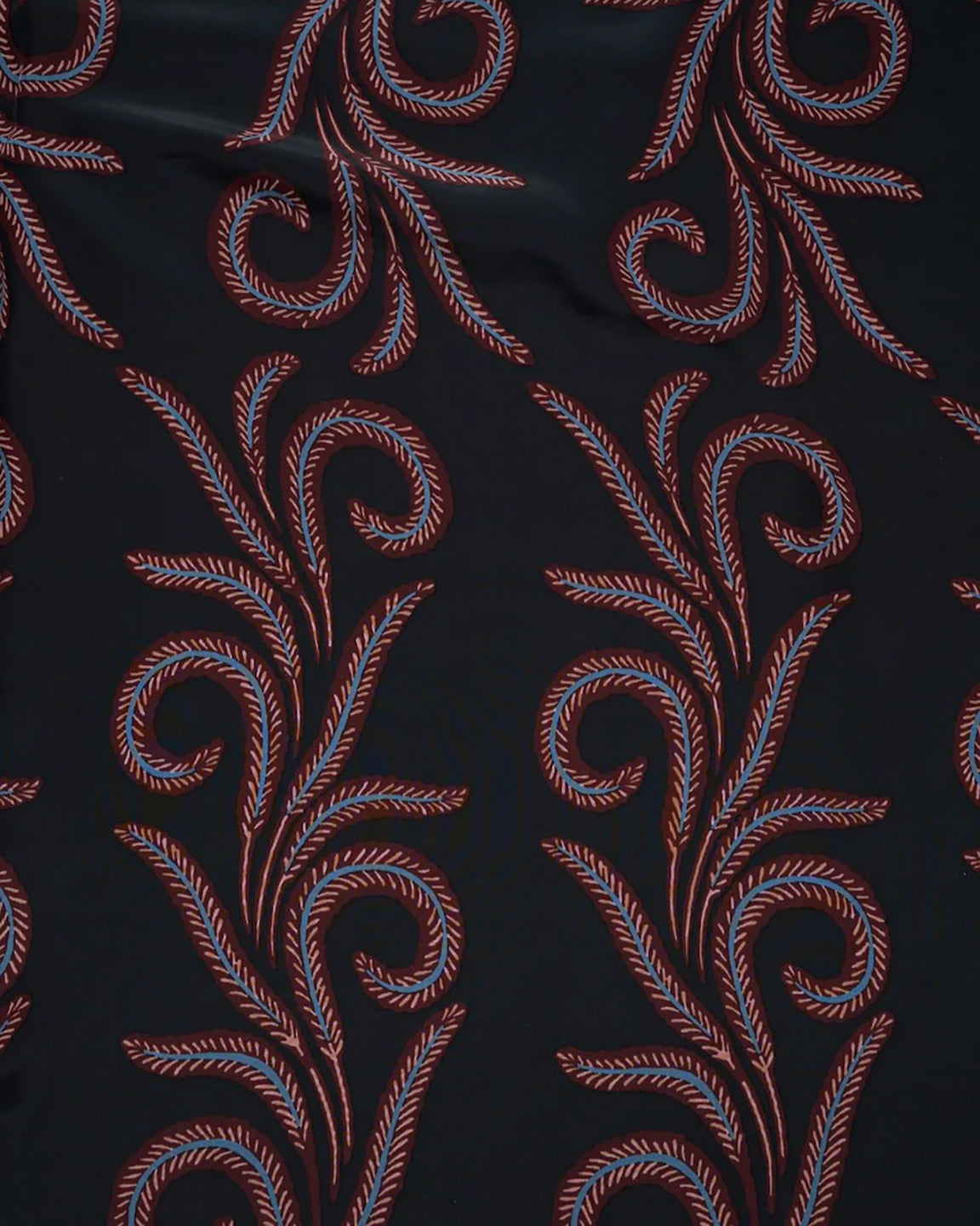 Decorative fabric with red floral patterns on a black background