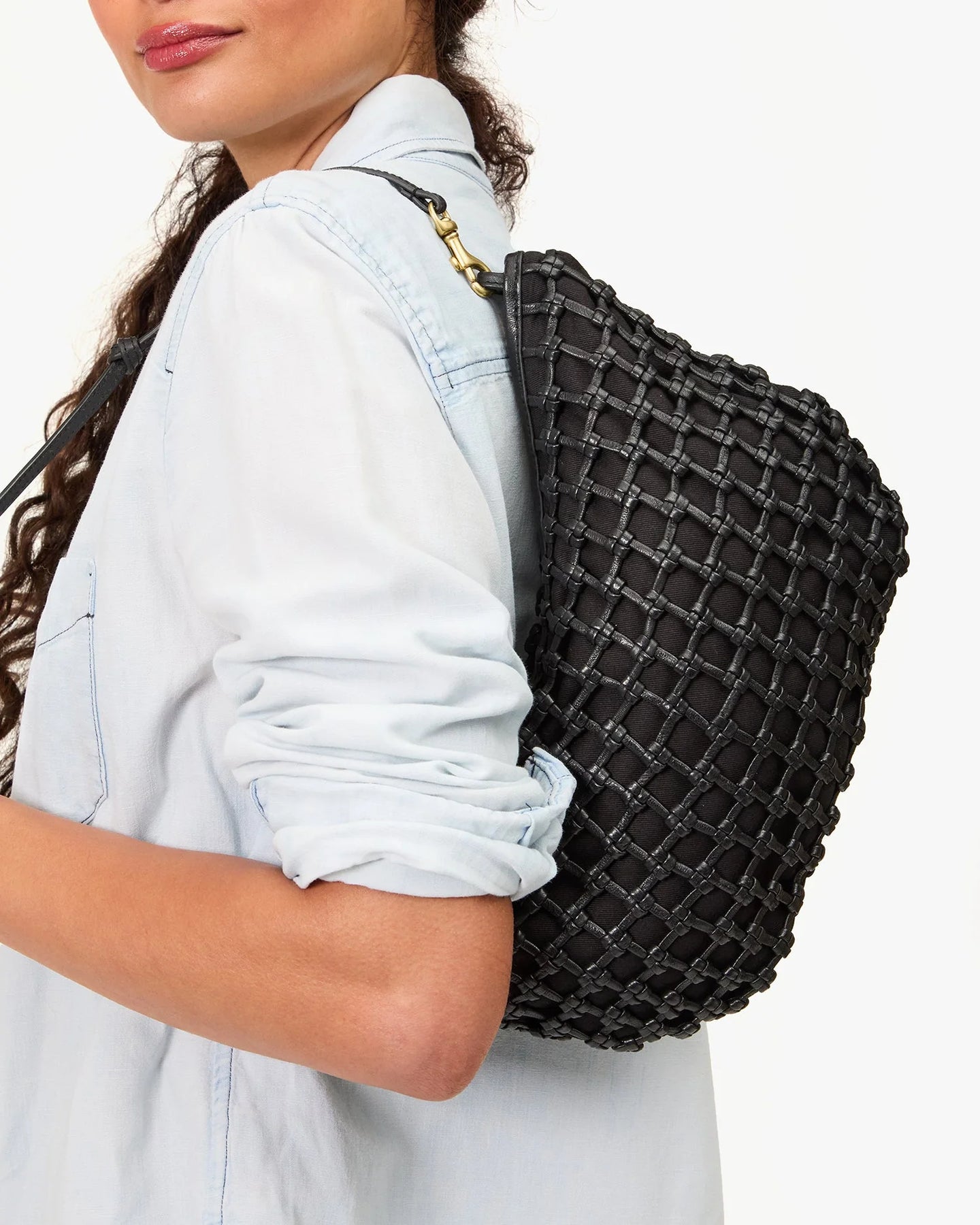 Person wearing a black woven backpack