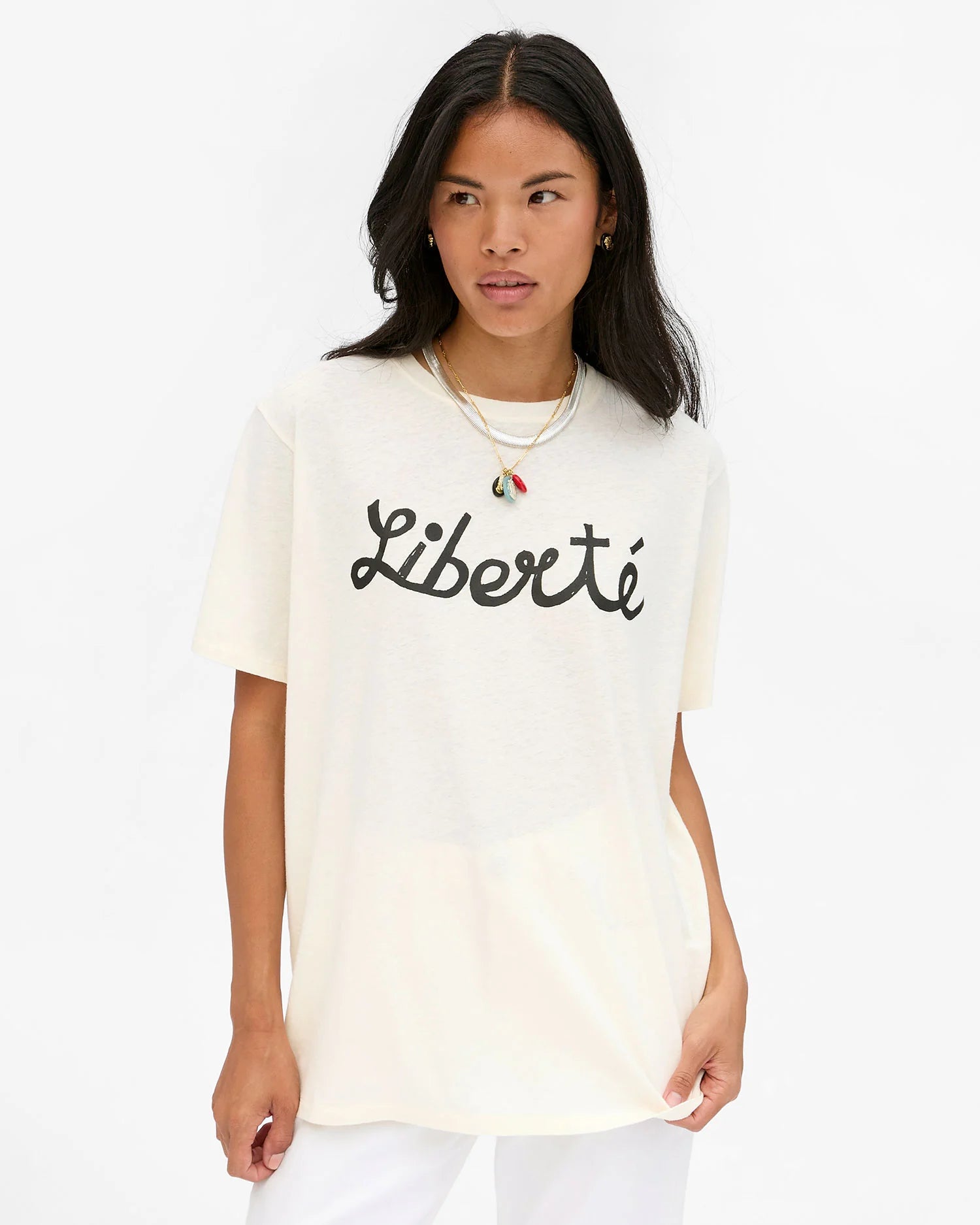 Woman wearing a white t-shirt with 'Liberté' text on a white background