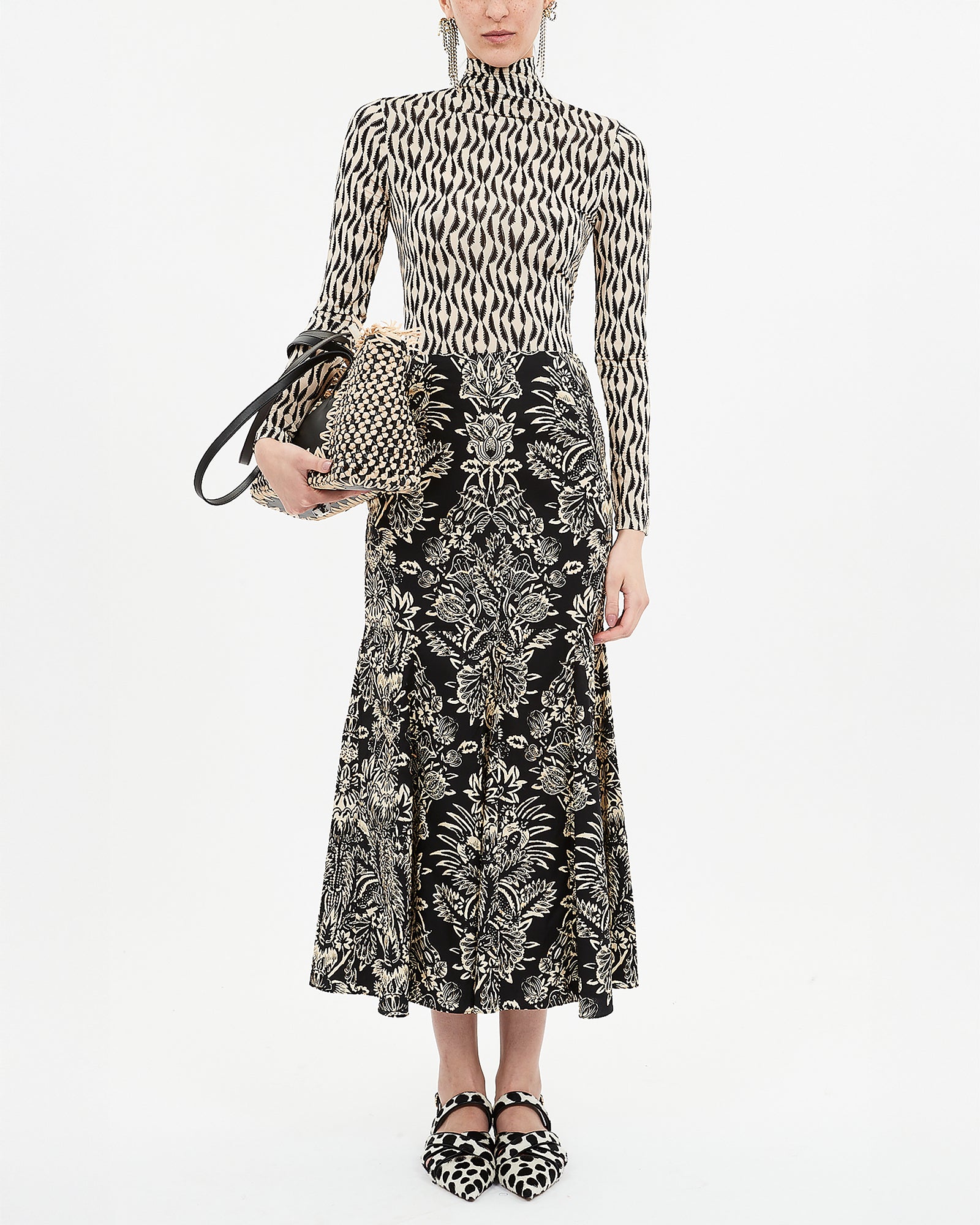 Person wearing a patterned outfit with a white background