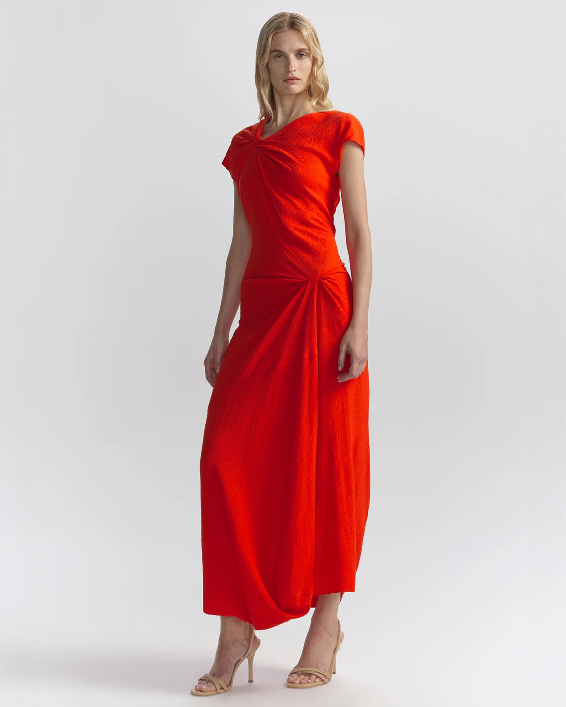 Woman wearing an orange dress on a white background