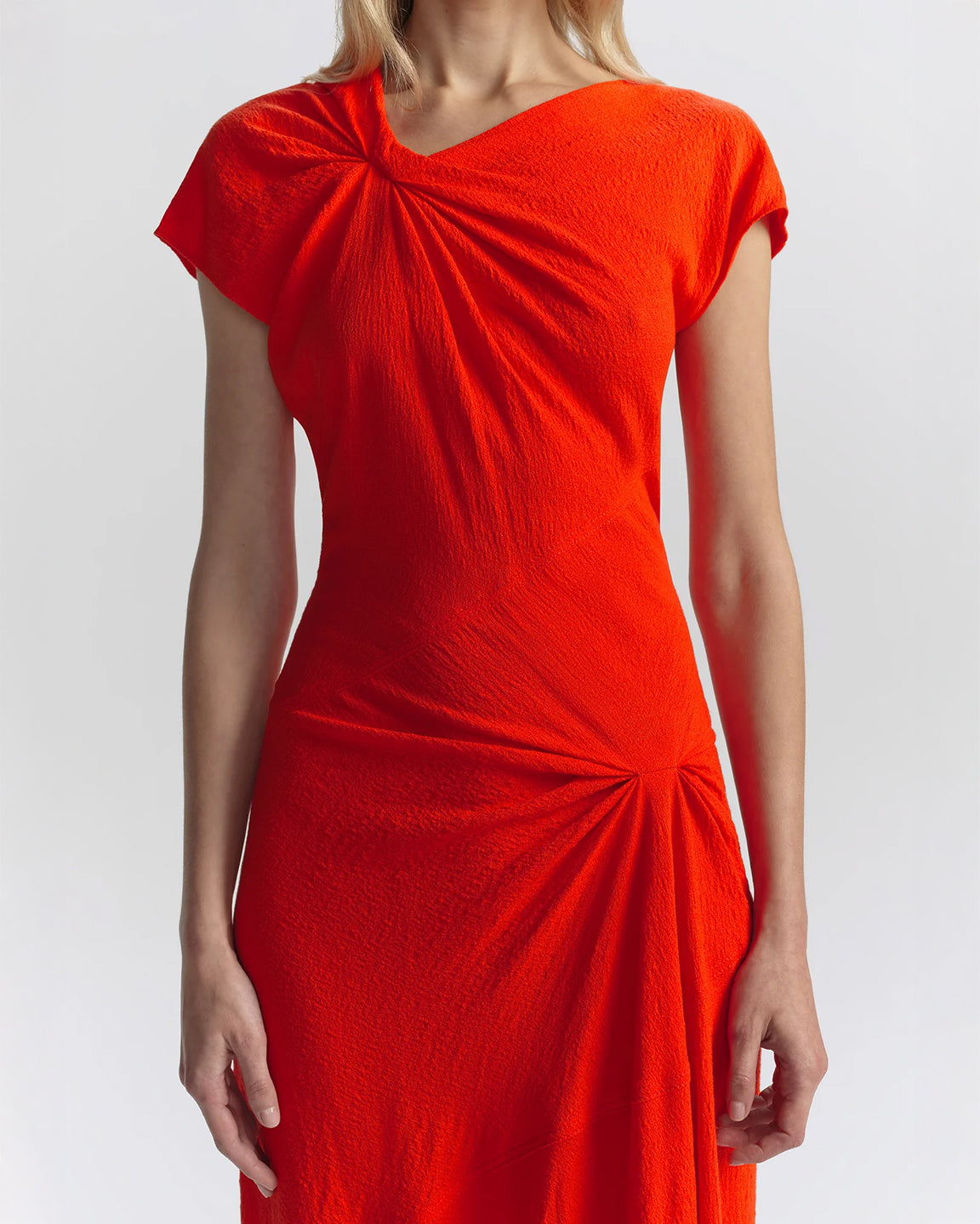Orange dress with a ruched design on a white background