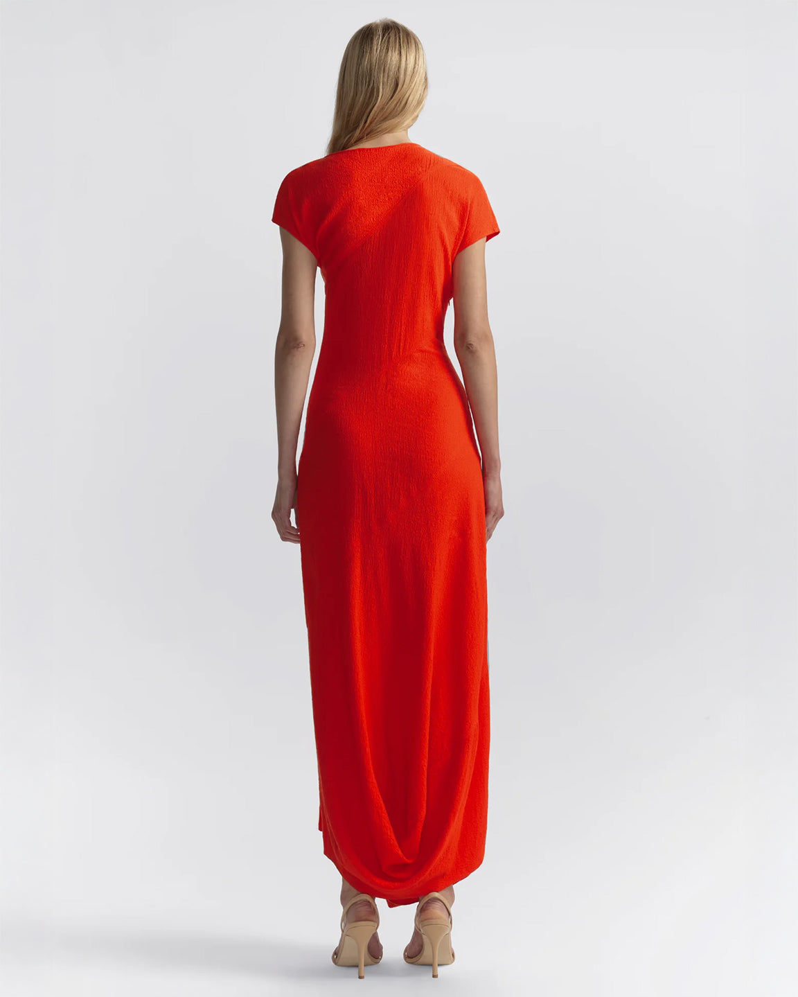 Woman wearing a red dress on a white background