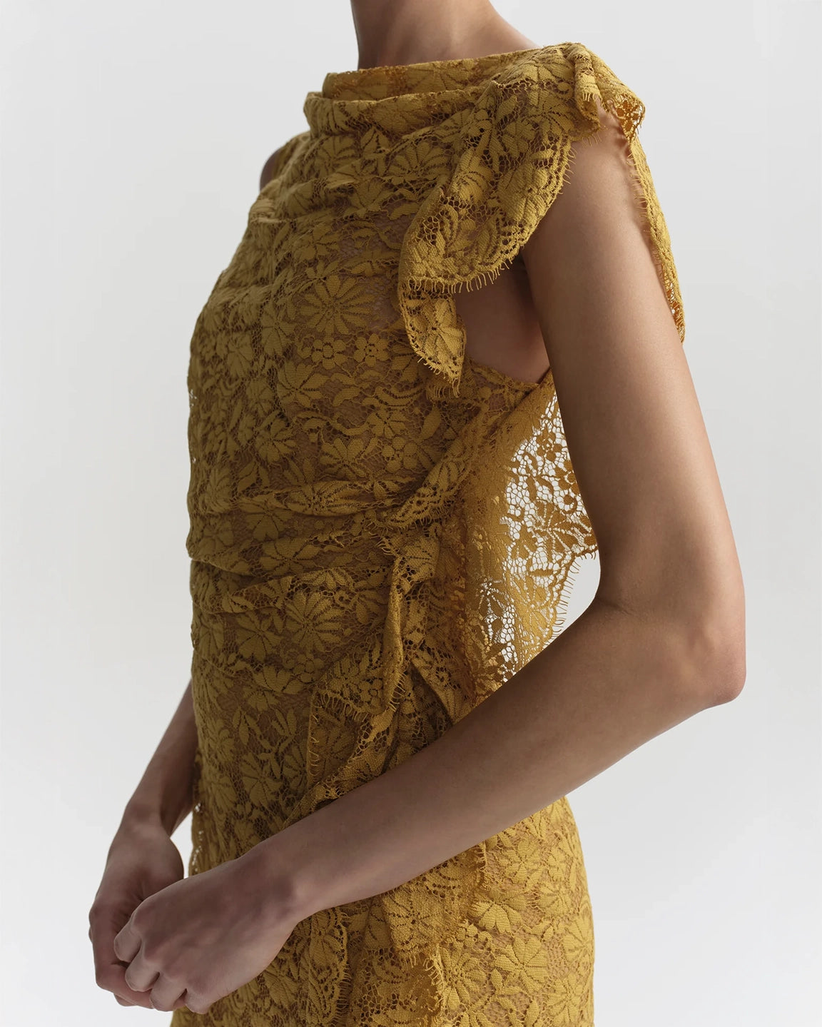 Yellow lace dress with ruffled shoulders on a white background