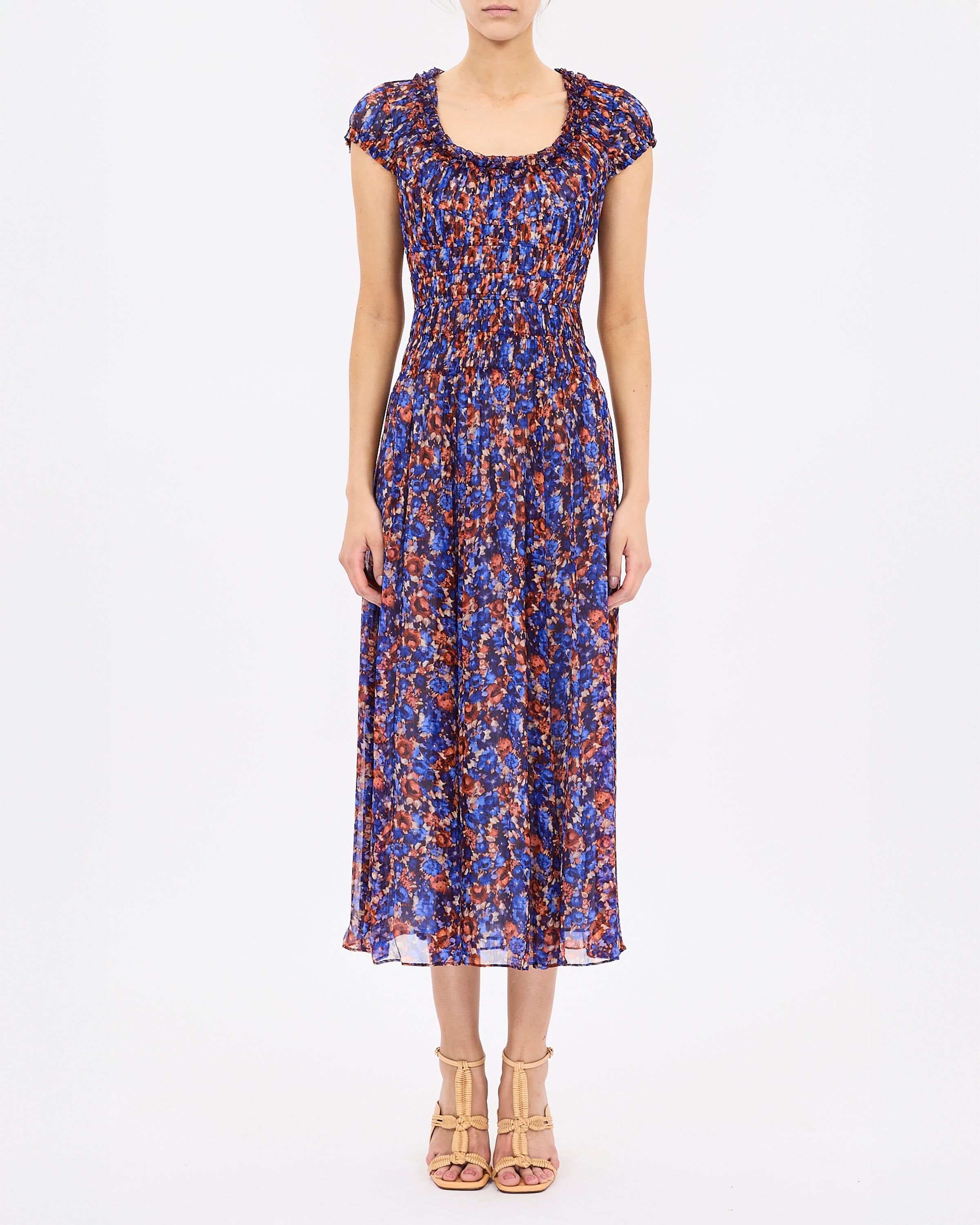 Woman wearing a patterned dress on a white background