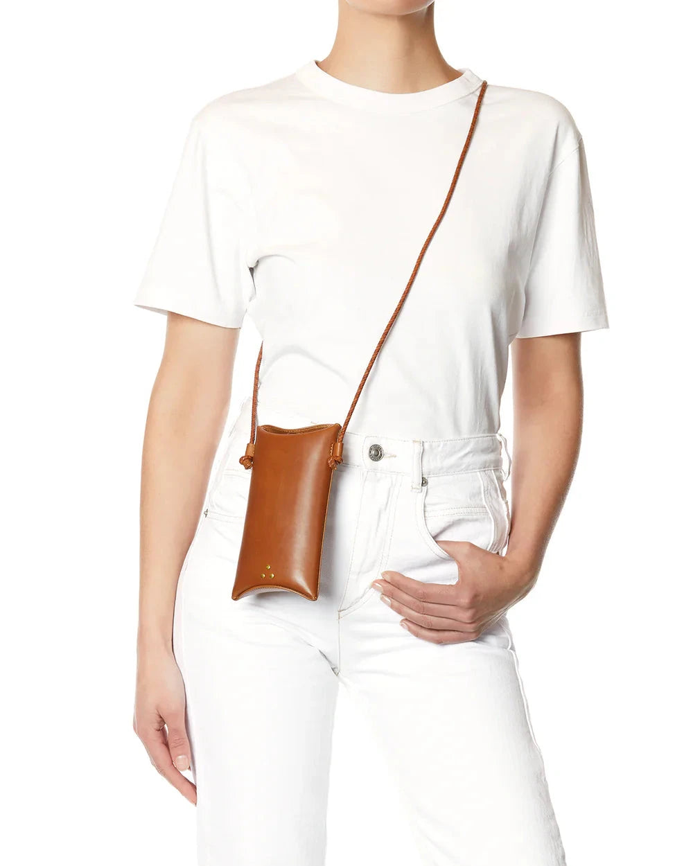 Person wearing a white t-shirt and white pants with a brown crossbody bag.
