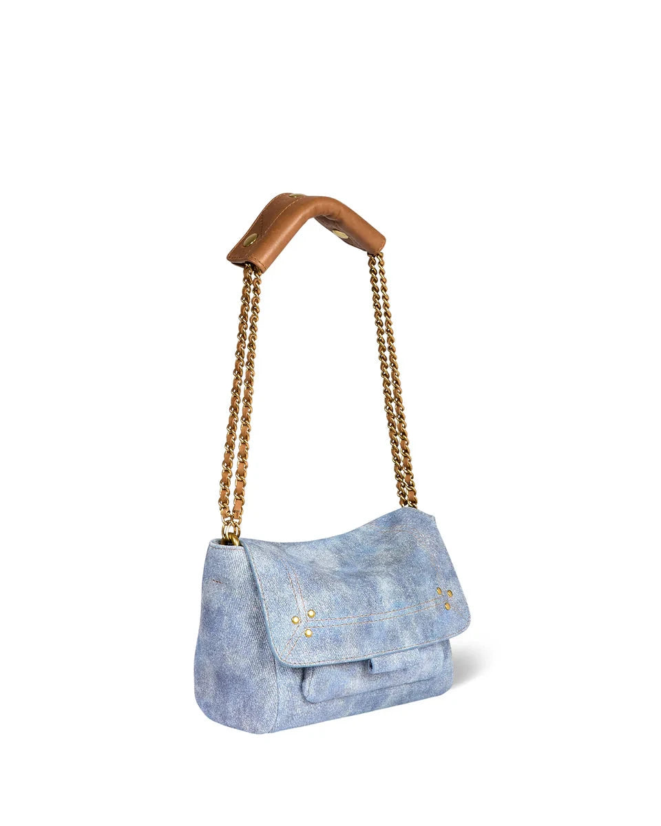 Blue denim handbag with wooden handle on a white background