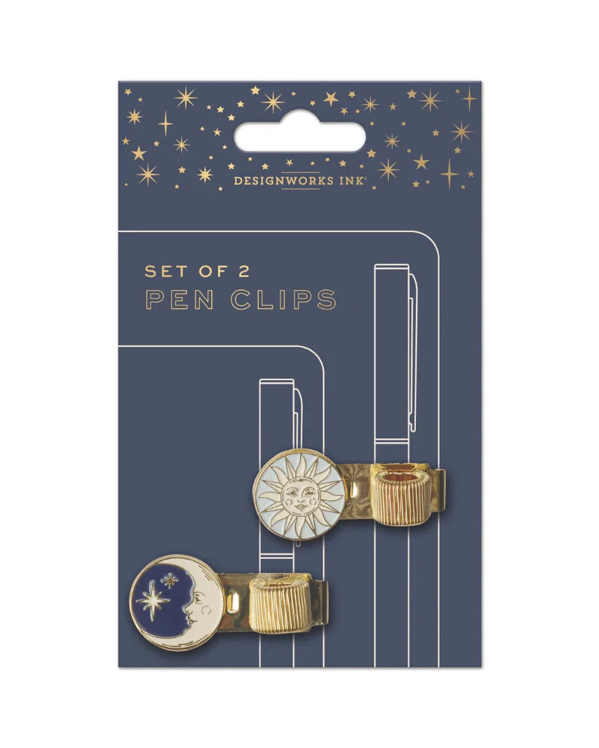 Packaging of two pen clips with celestial designs on a blue background