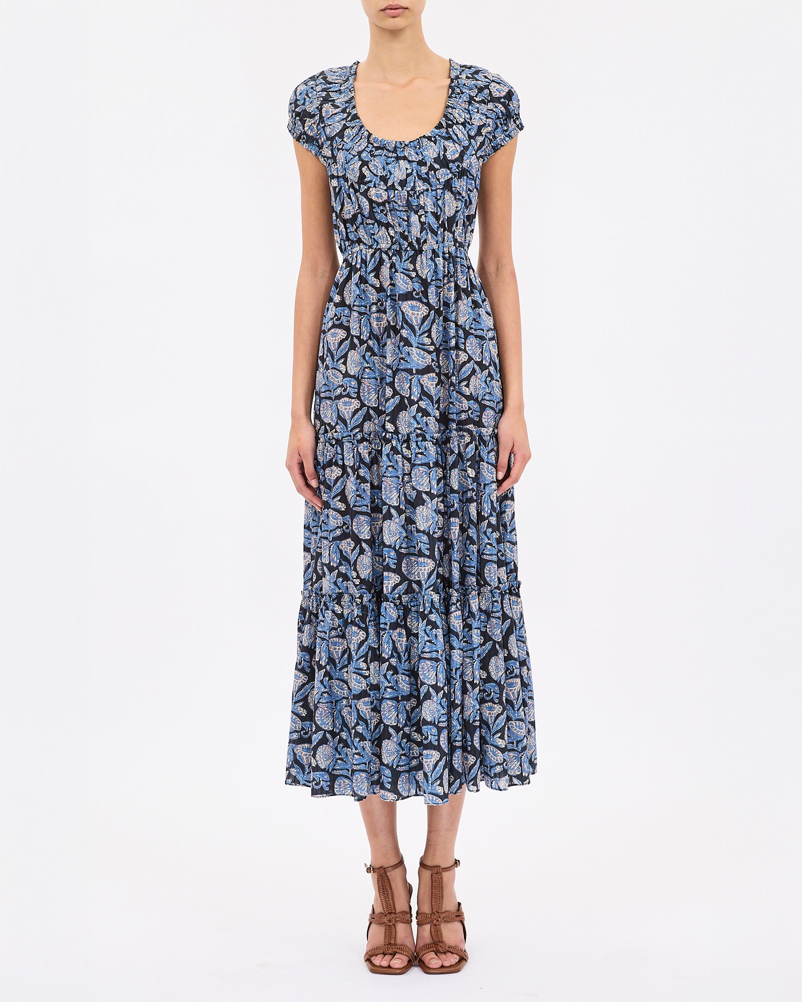 Woman wearing a blue floral dress on a white background
