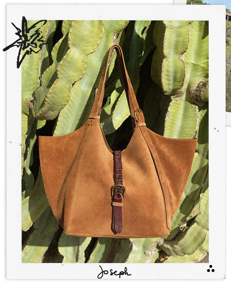 Brown suede handbag with braided detail against a cactus background, featuring the brand 'Joseph'.