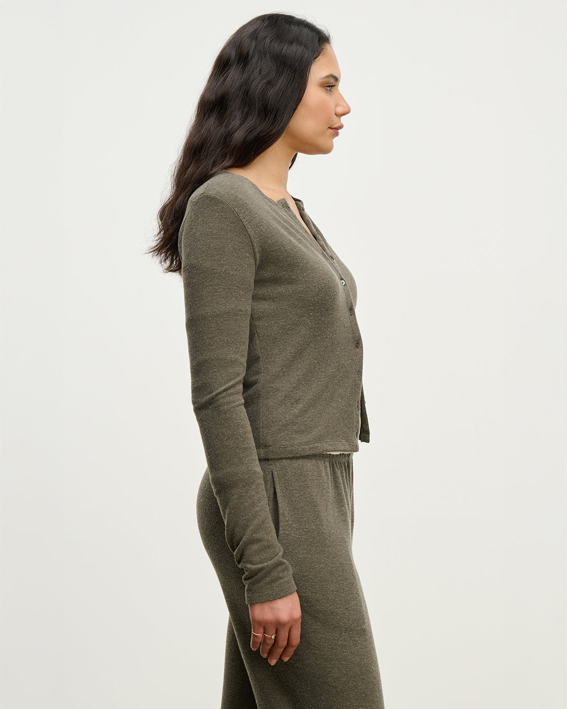 Side view of caridgan and sweatpants in a heathered olive color