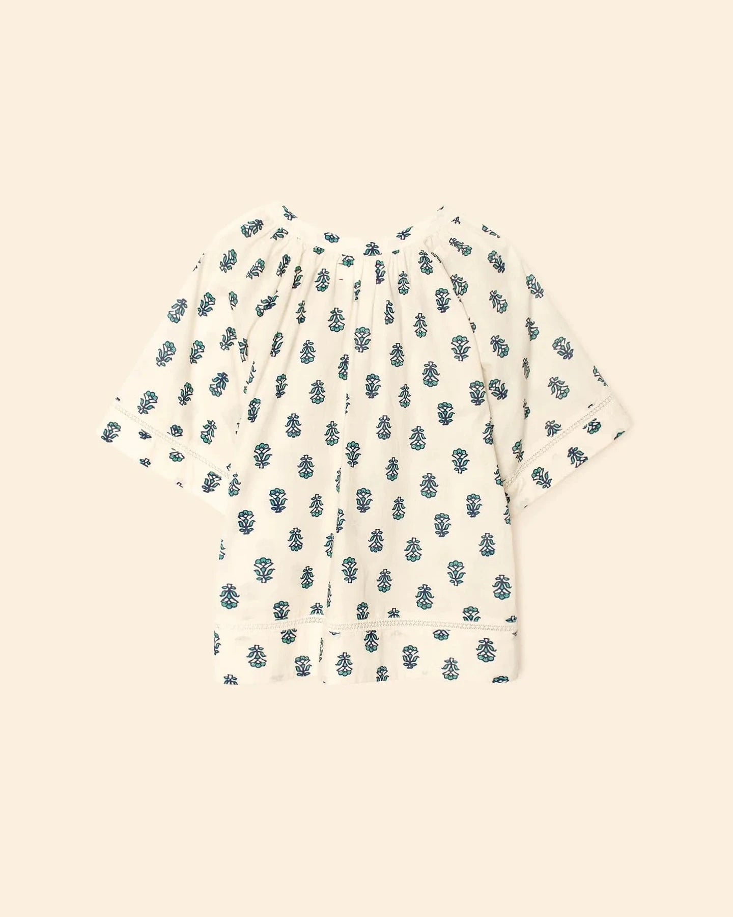 Short-sleeve shirt with blue floral pattern on a beige background