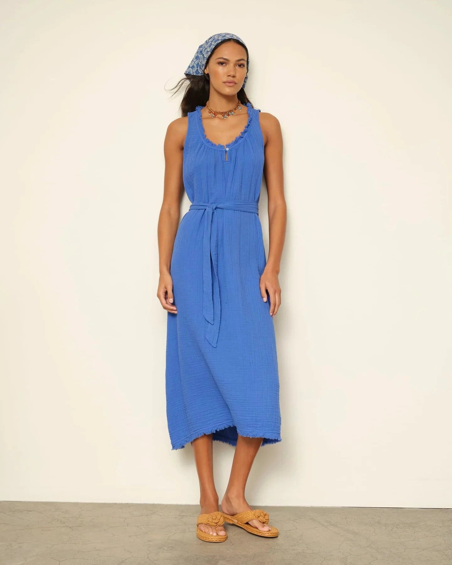 Woman wearing a blue dress with a white background