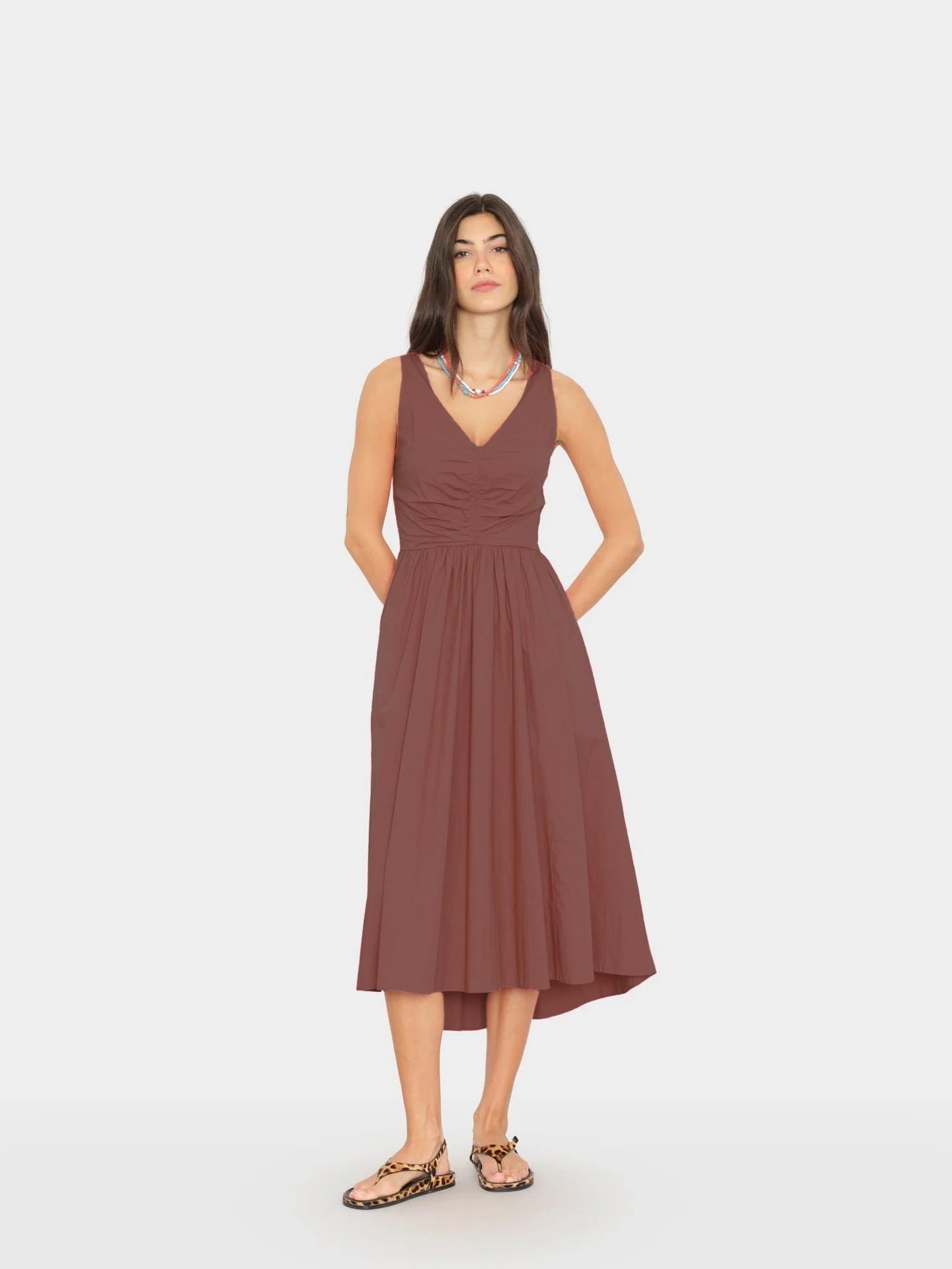 Woman wearing a brown dress on a white background