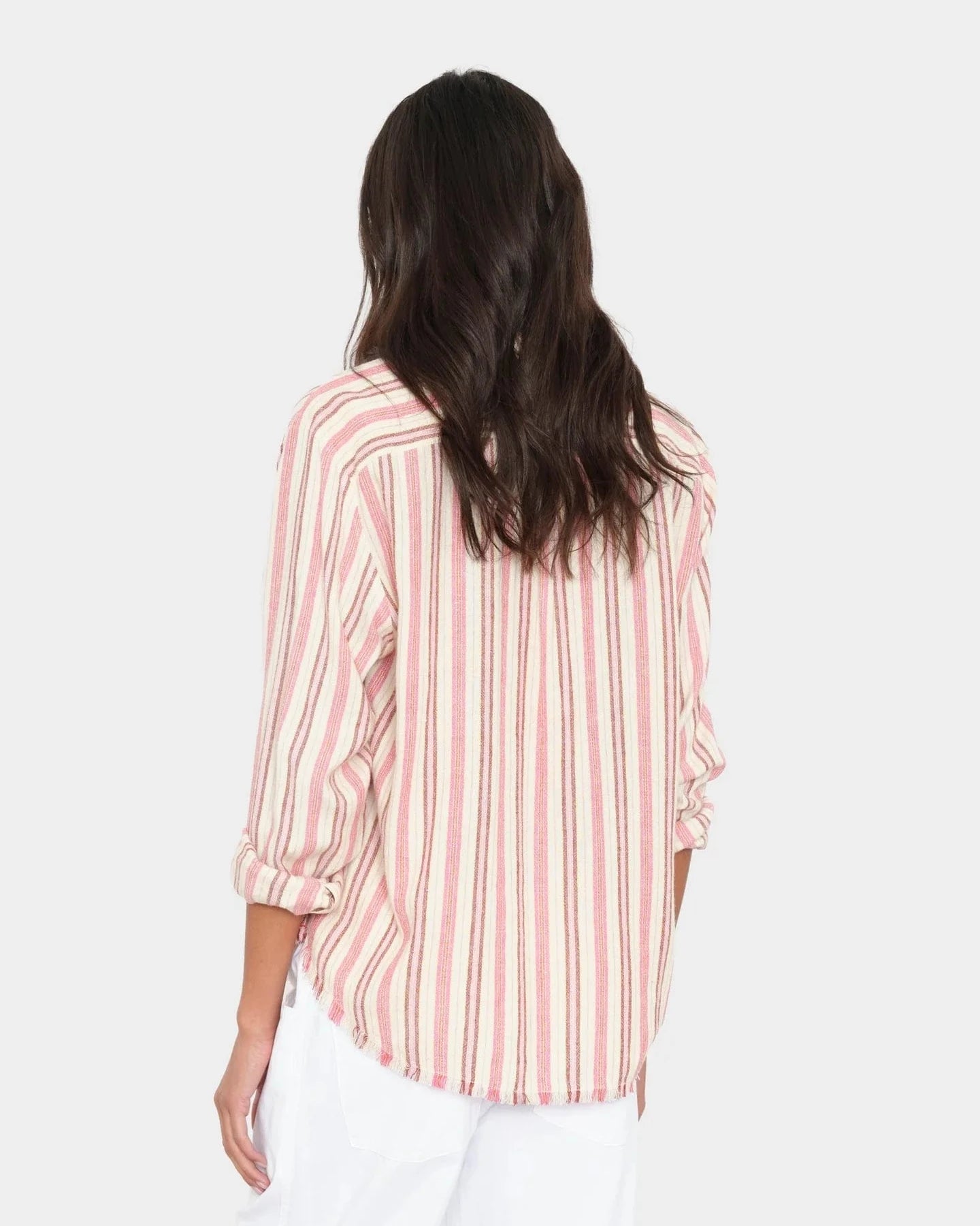 Woman wearing a pink and white striped shirt on a white background