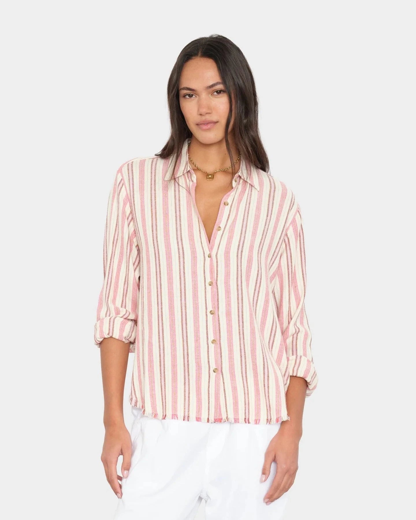 Woman wearing a striped shirt with a plain background