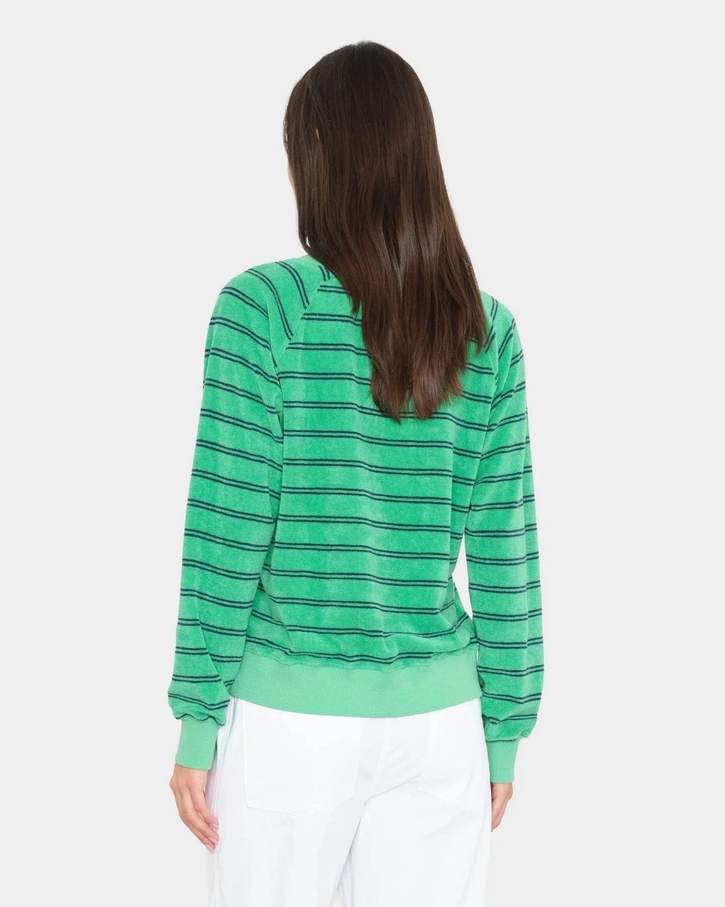 Person wearing a green striped sweater on a white background