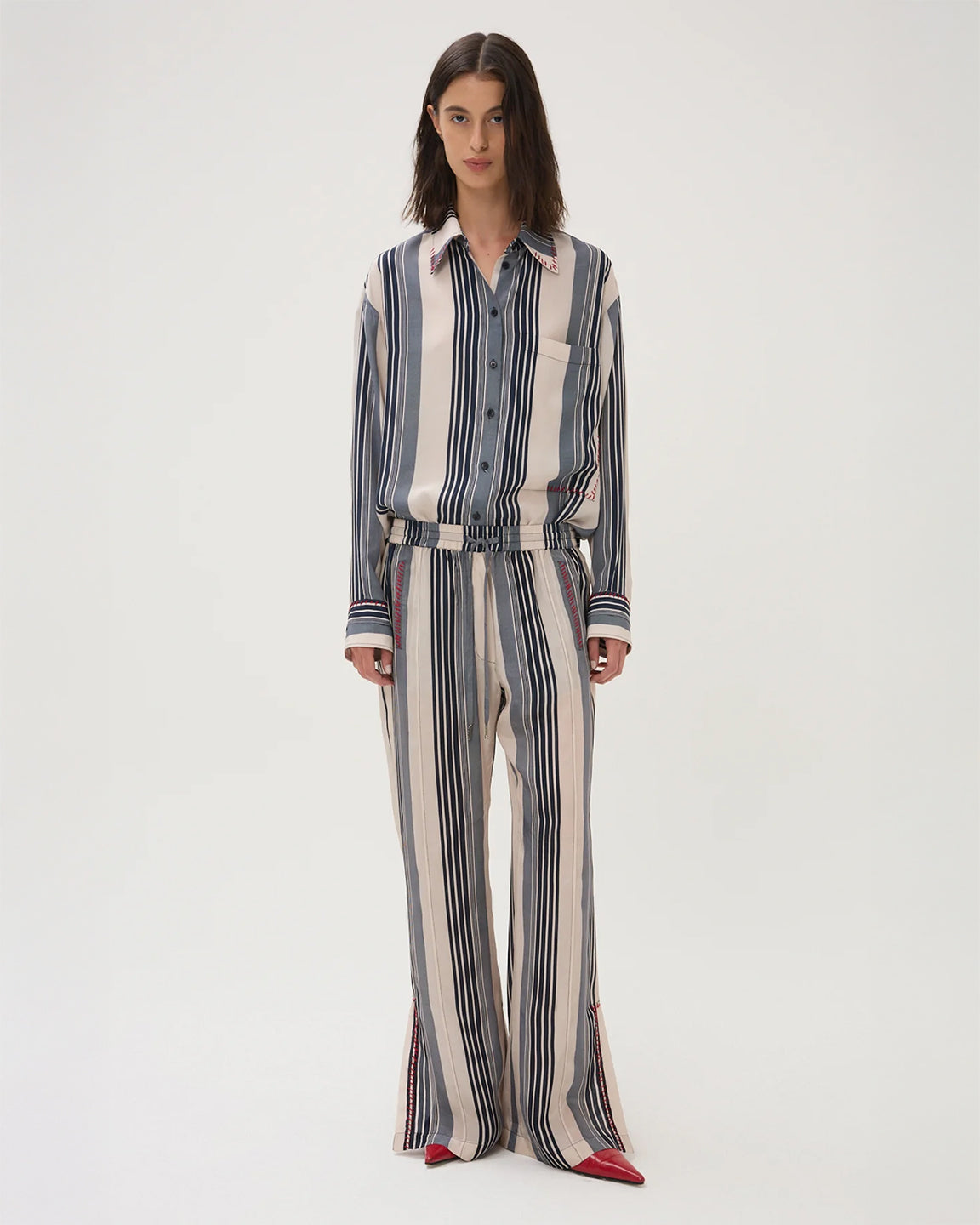 Woman wearing a striped shirt and pants set on a white background
