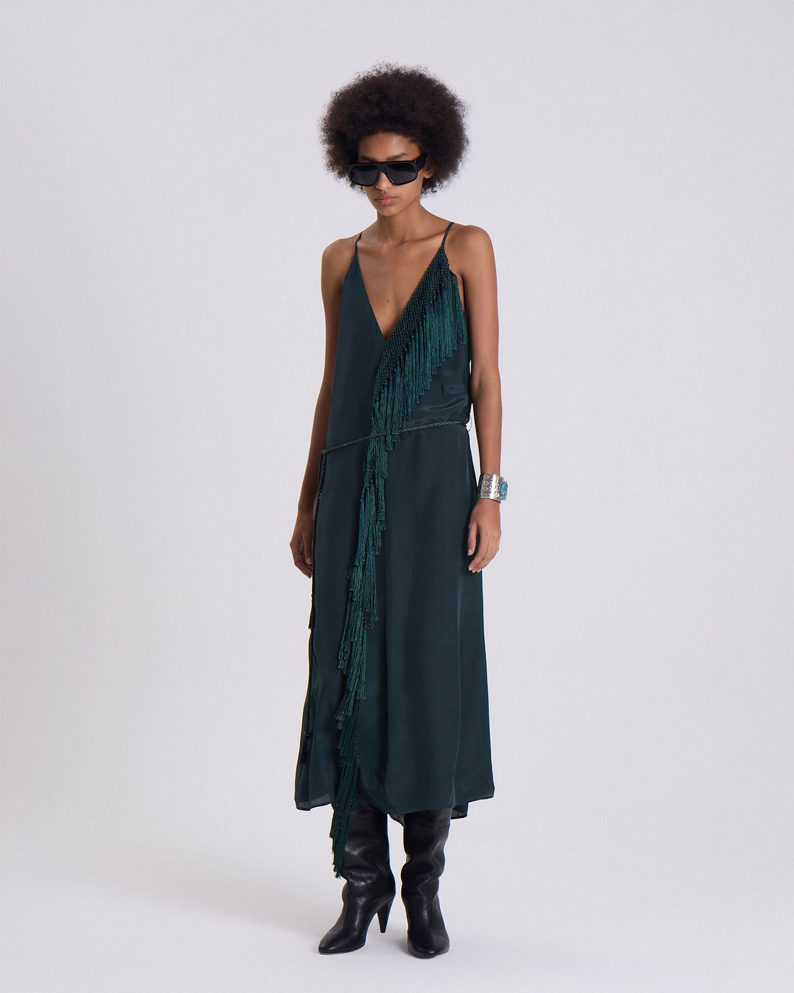 Woman wearing a dark green dress with a white background