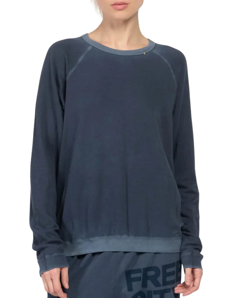 Navy blue long-sleeve shirt worn by a person on a white background
