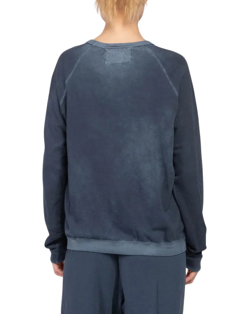Person wearing a dark blue sweatshirt and pants on a white background