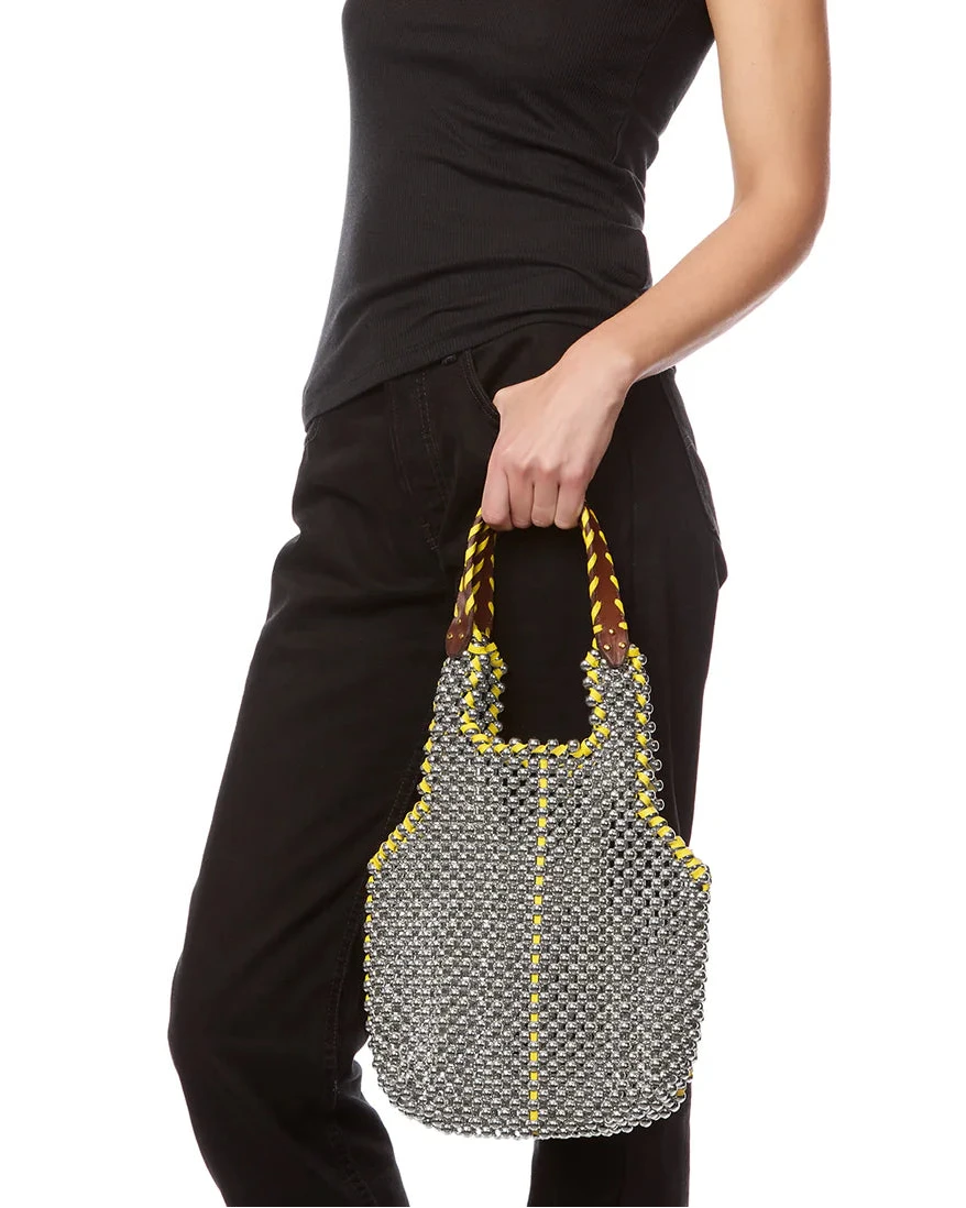 Person holding a textured handbag with a white background