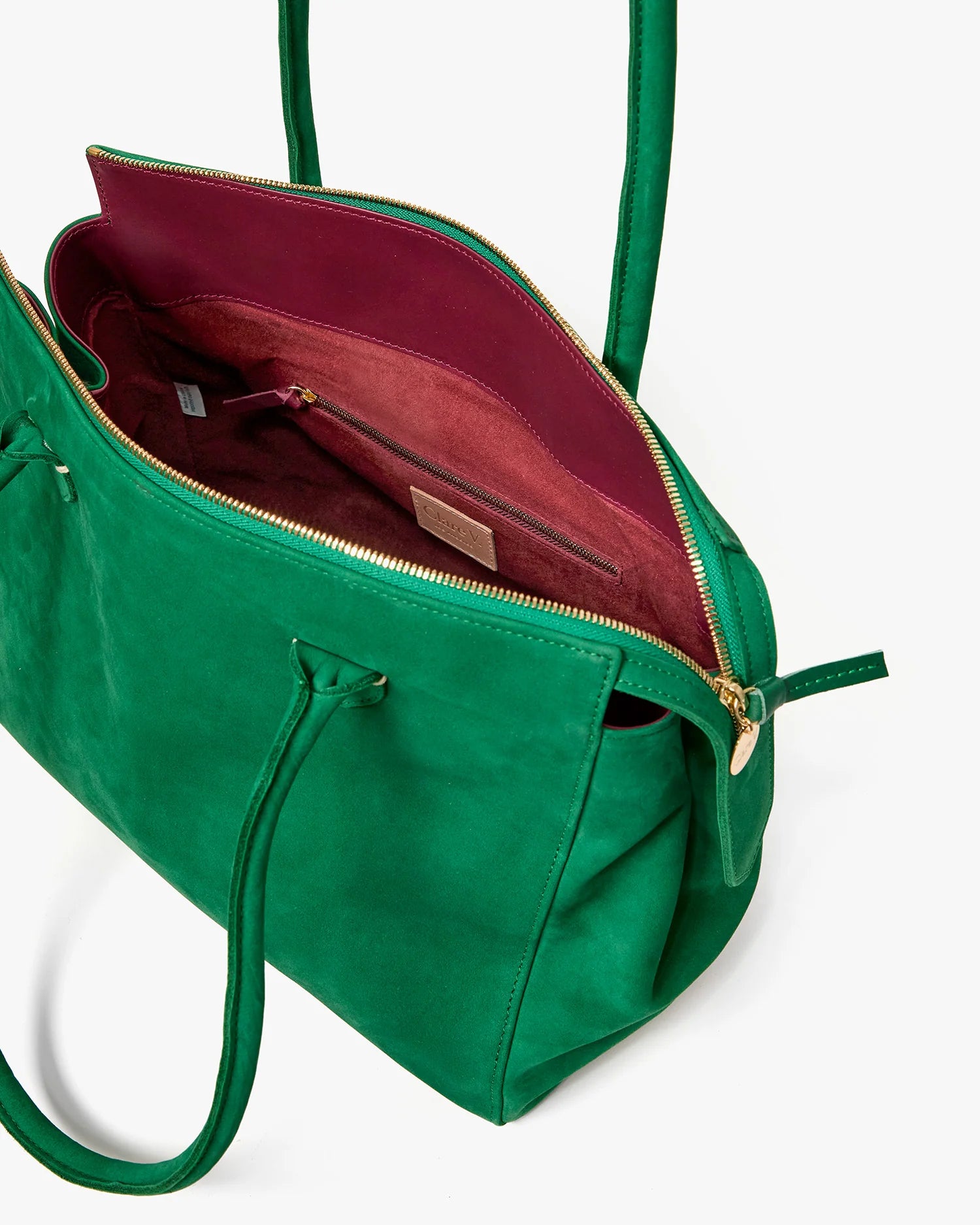 Green handbag with open top showing red interior on a white background