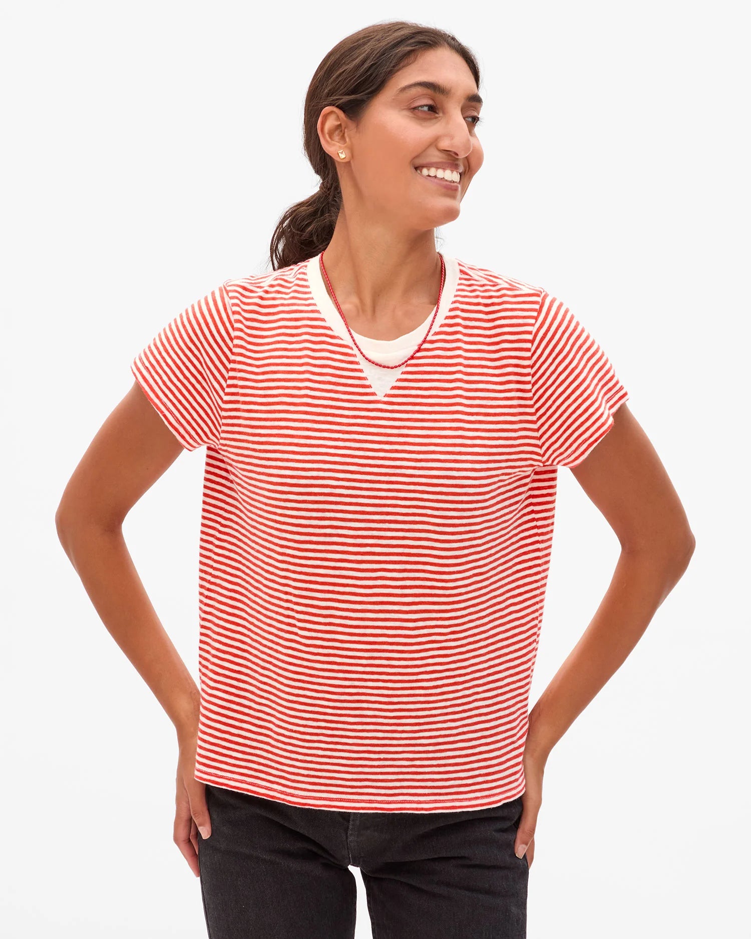 Woman wearing a red and white striped shirt on a white background