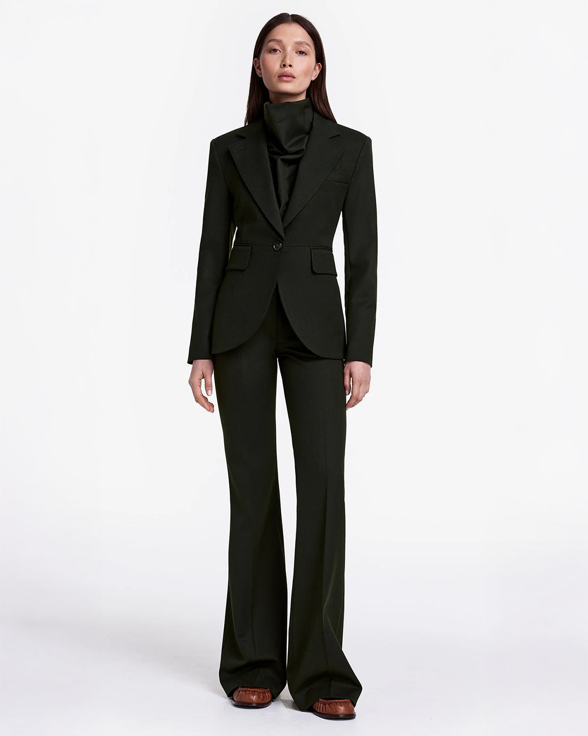 Person wearing a dark green suit on a white background