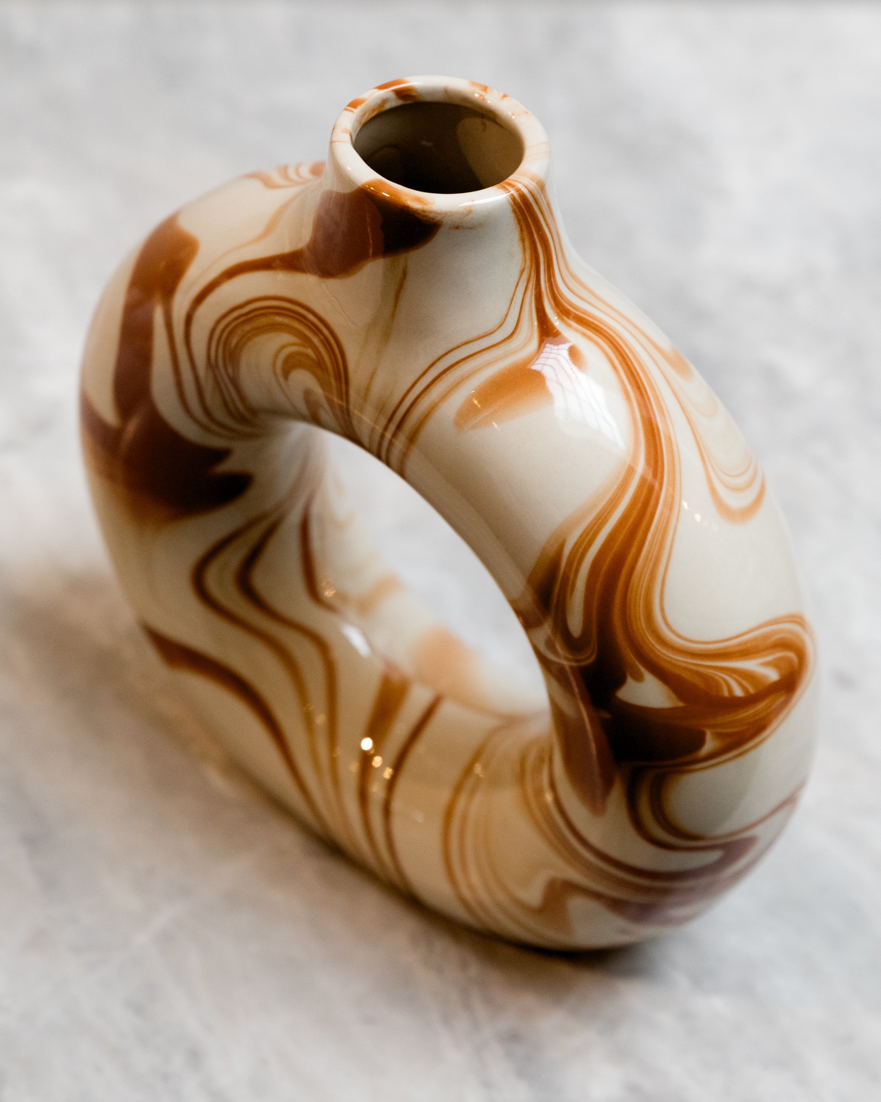 Marbled ceramic vase on a textured surface