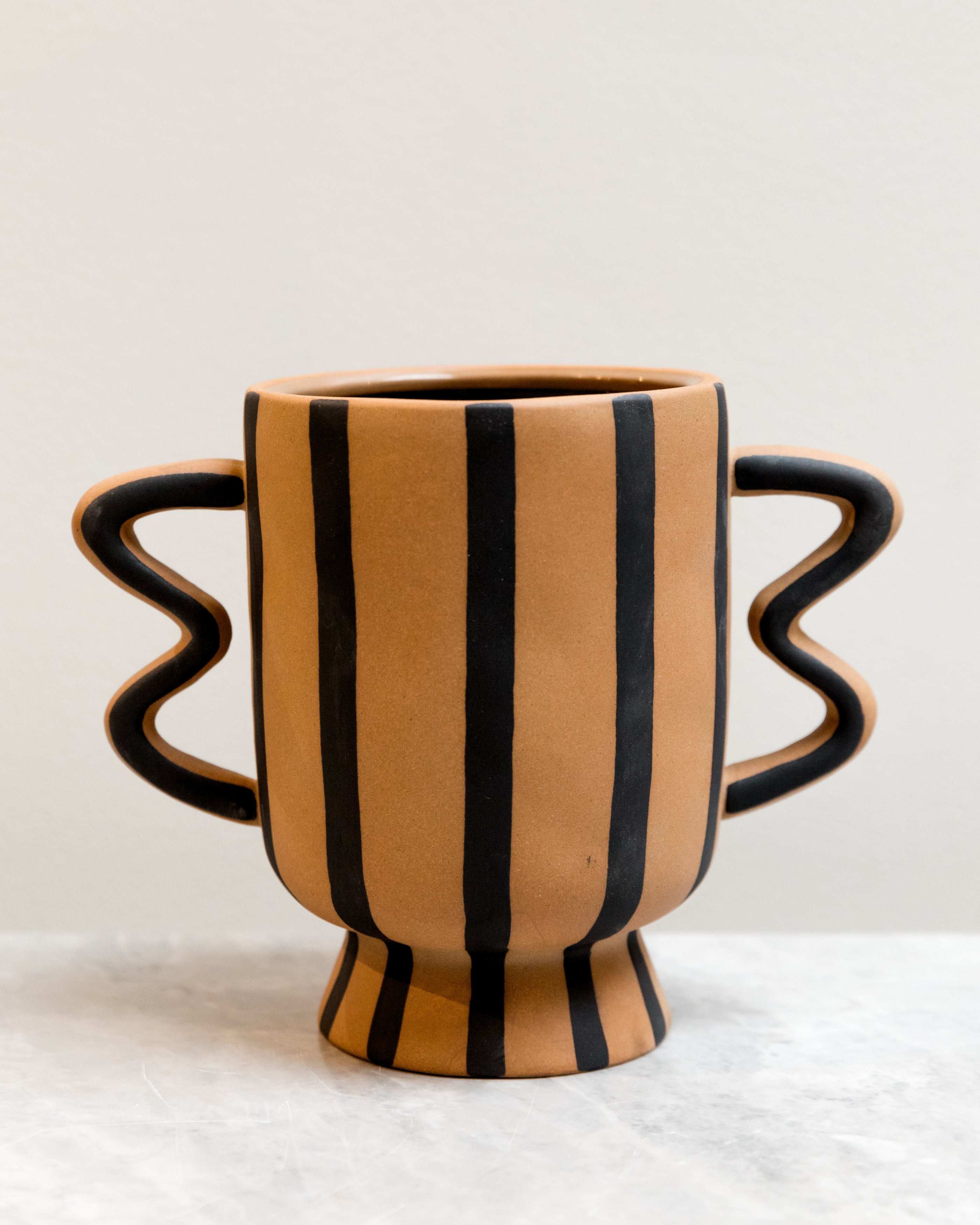 Ceramic mug with striped design on a white background