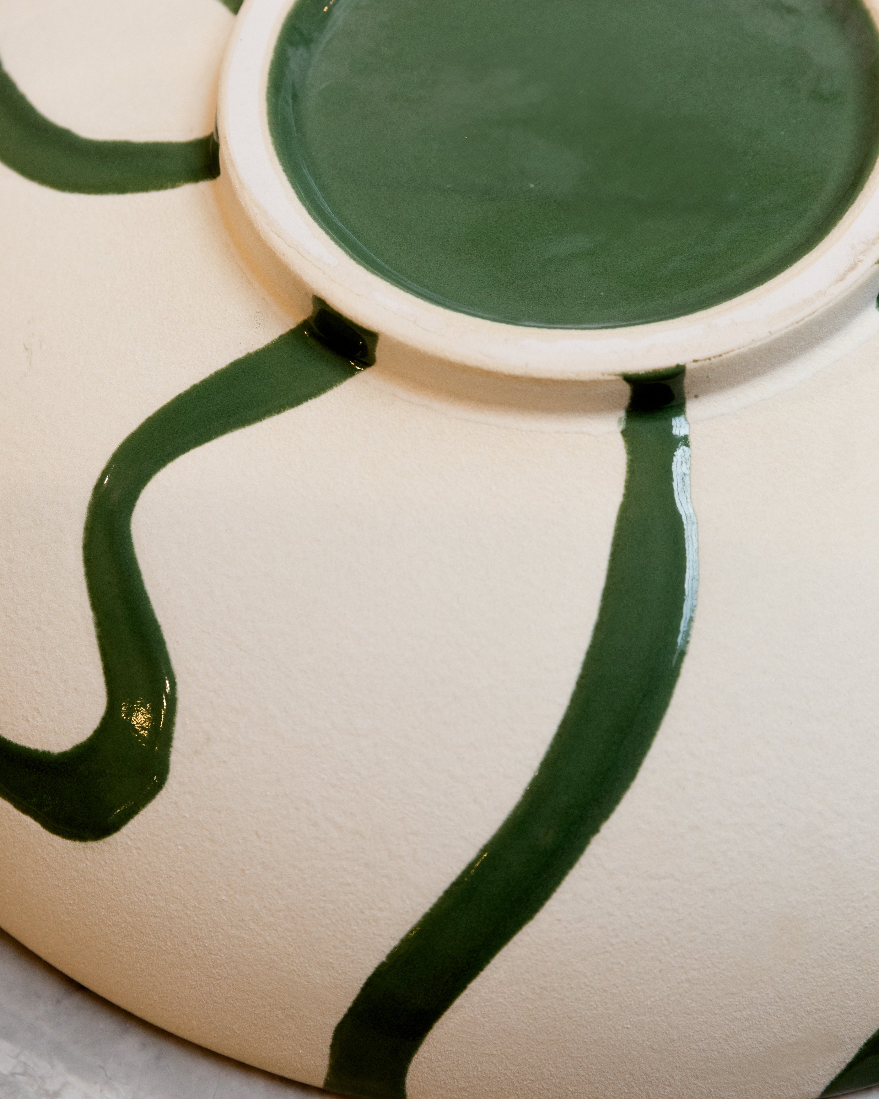 Ceramic vase with green accents on a white background