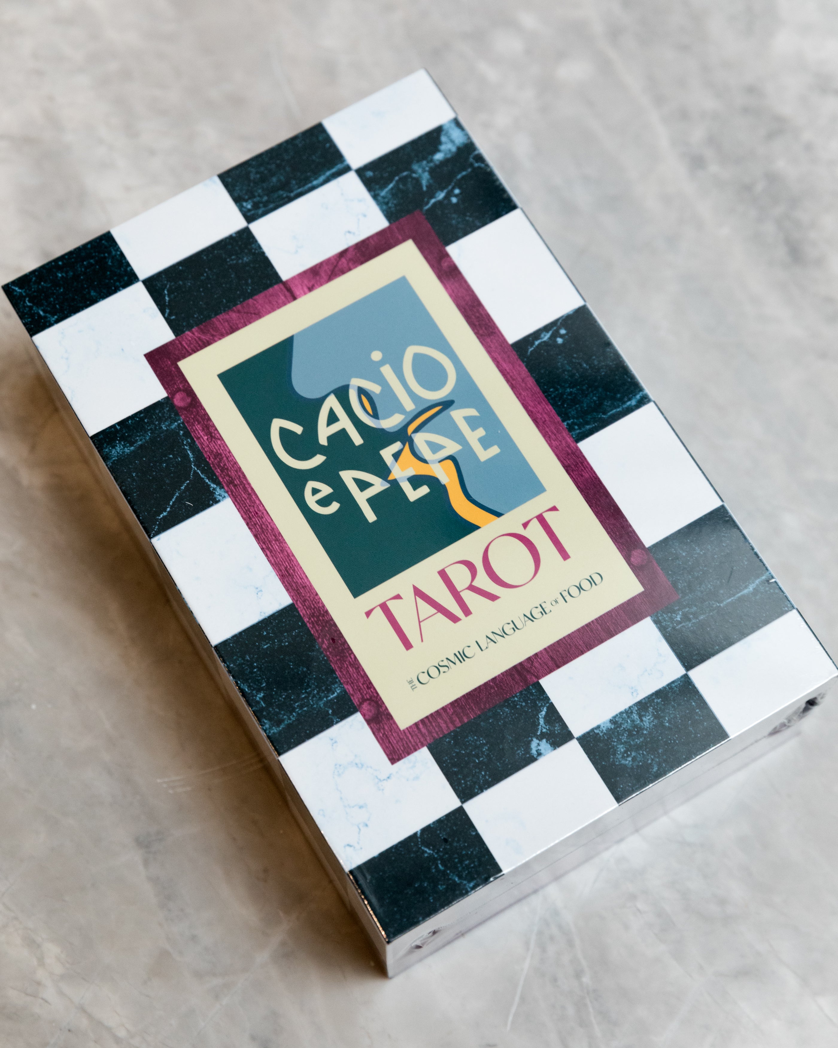 black and white checkerboard box with cario e pepe tarot on the outside