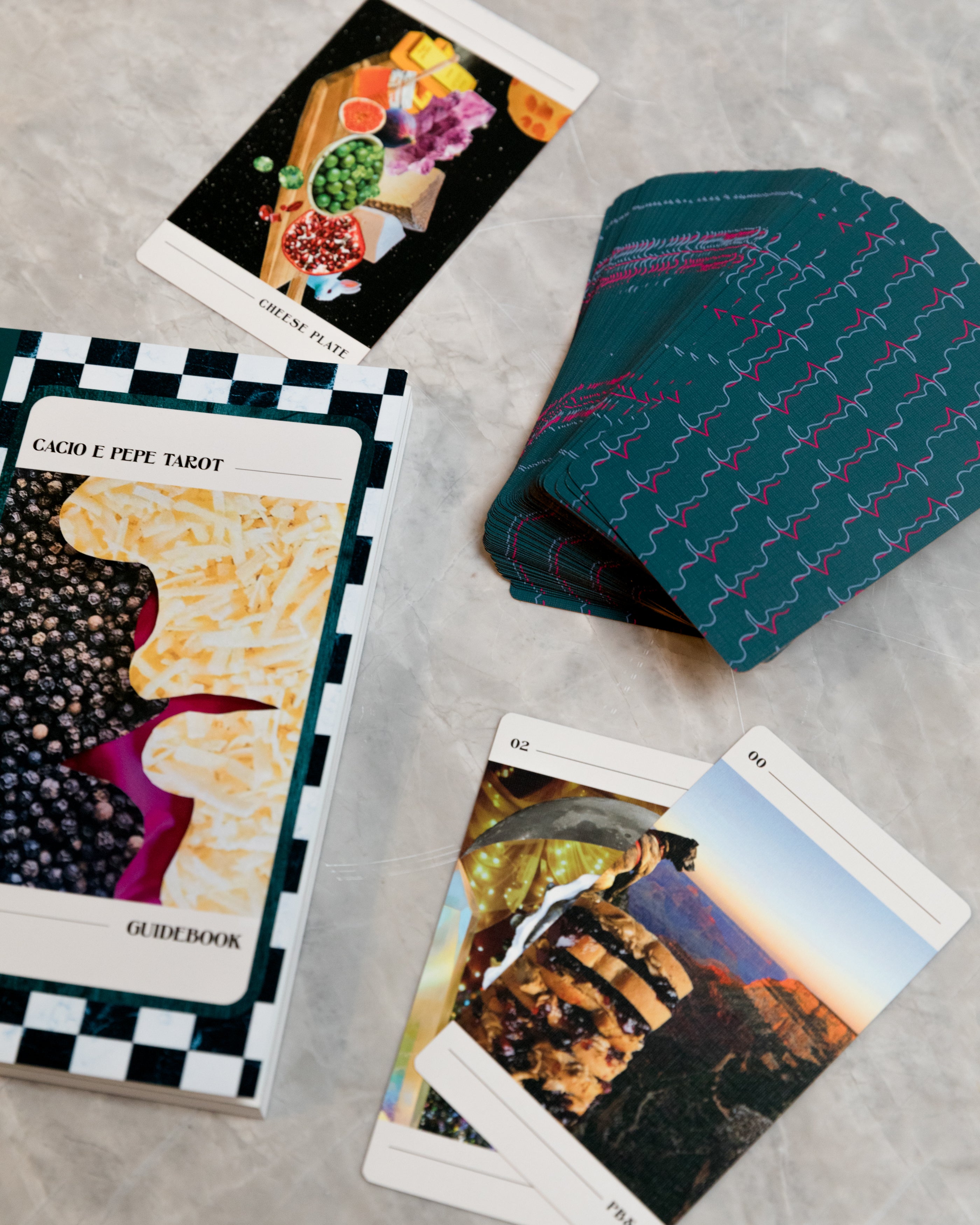 tarot deck and guidebook on a grey surface
