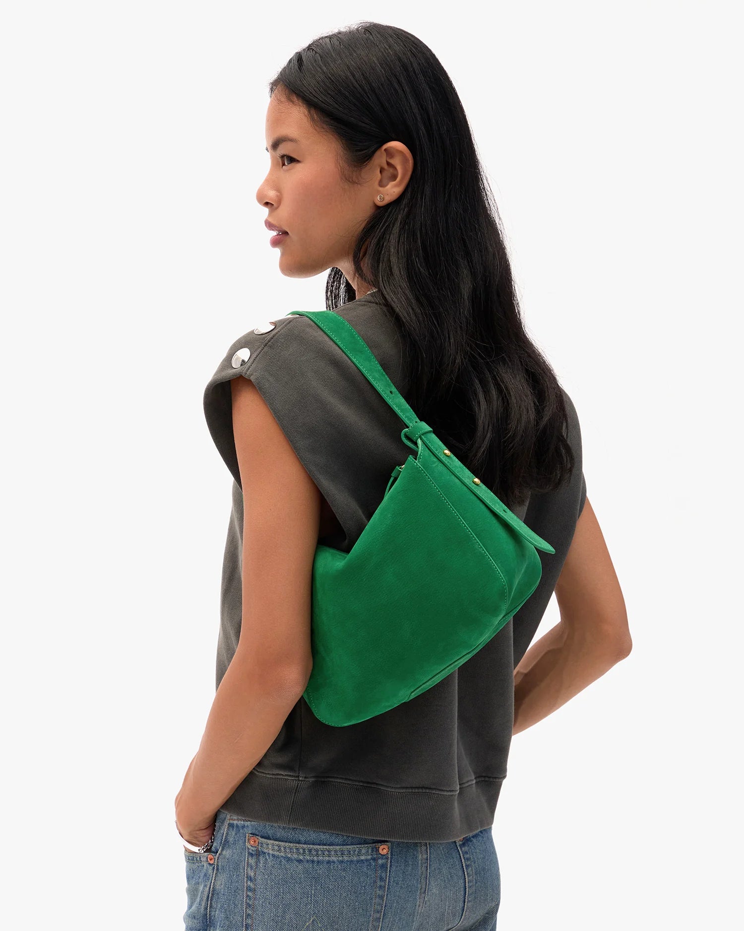 Person wearing a green backpack on a white background