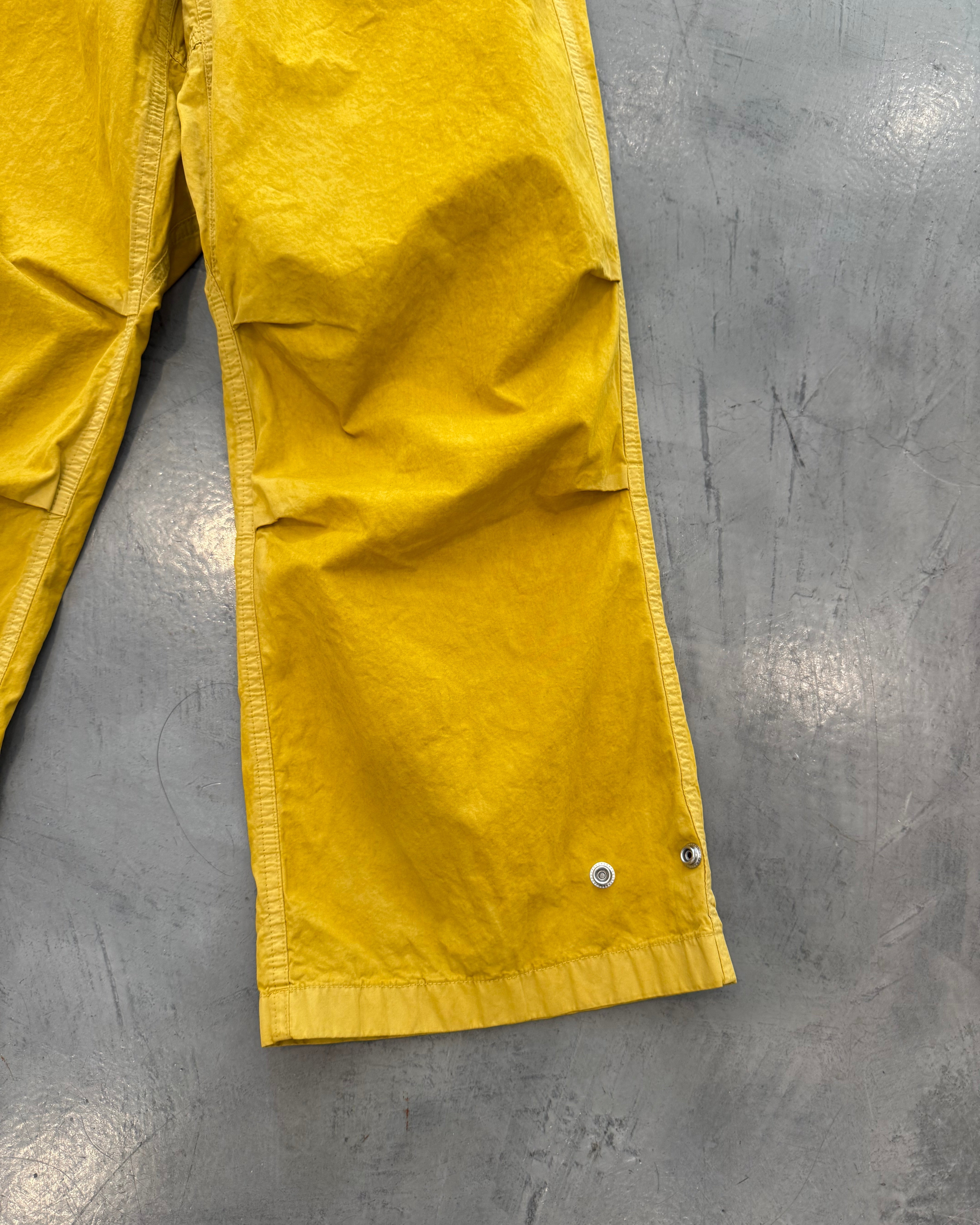 Yellow tarp on a gray concrete floor