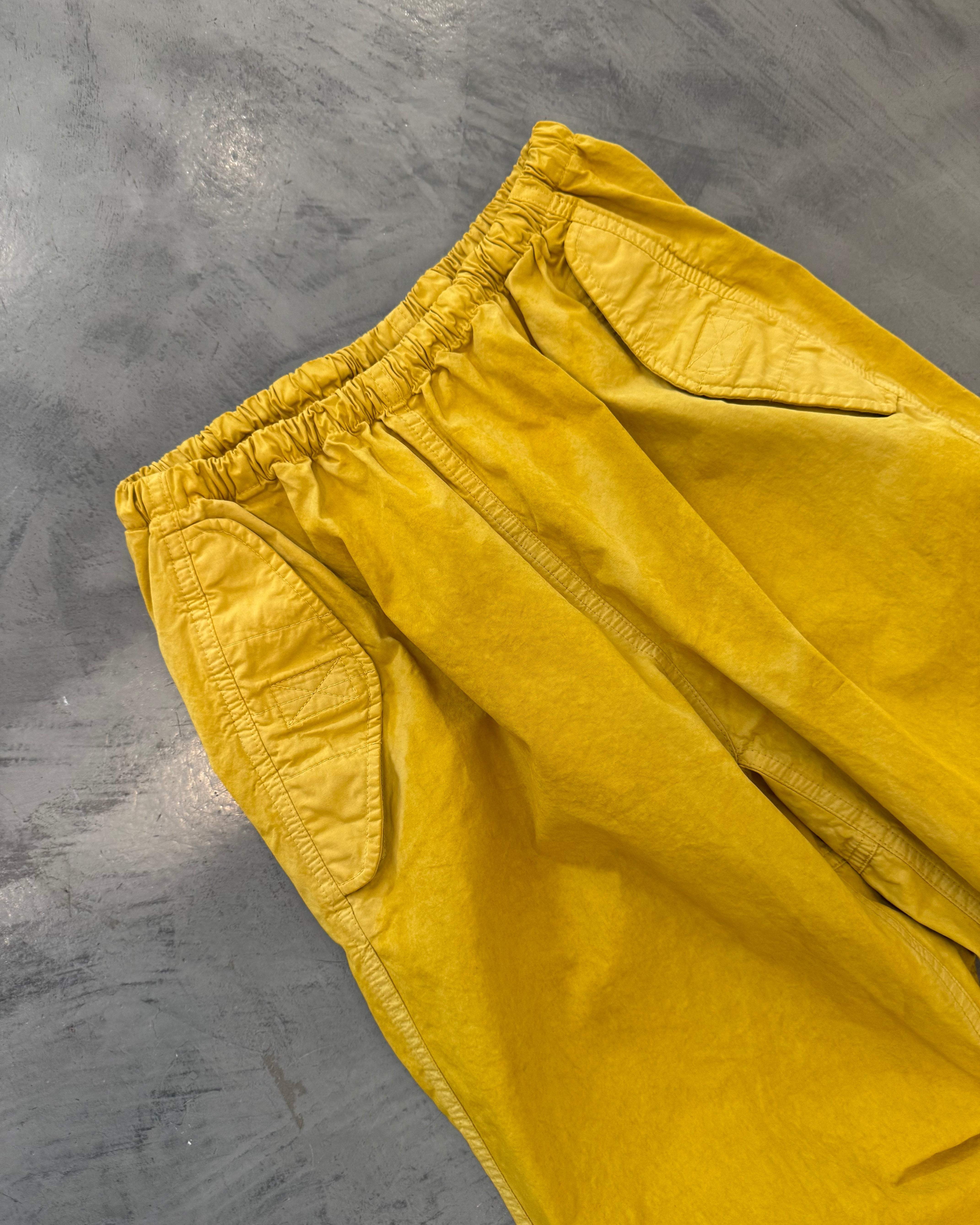 Yellow pants on a gray concrete surface