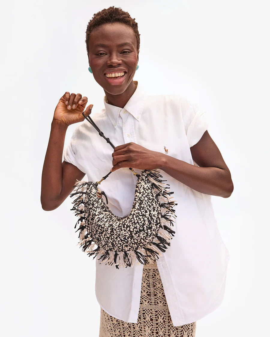Woman holding a woven bag with a white background