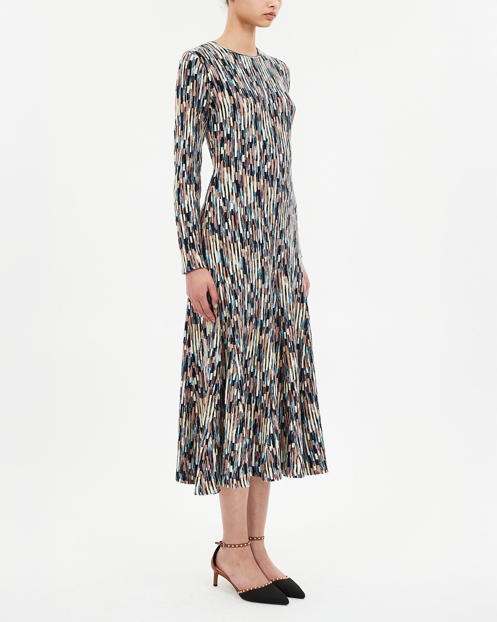 Woman wearing a patterned dress on a white background