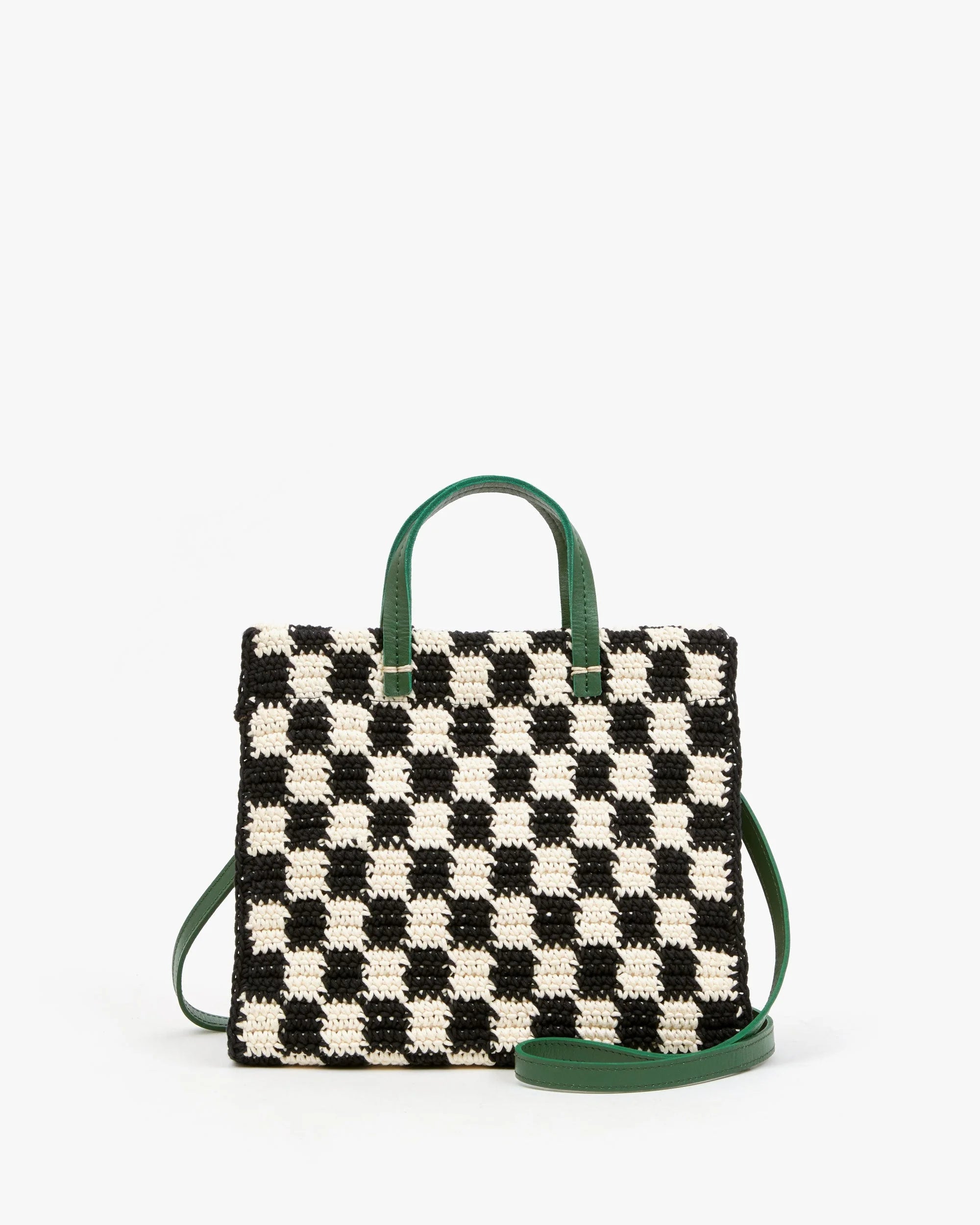 Black and white checkered handbag with green handles and strap on a white background